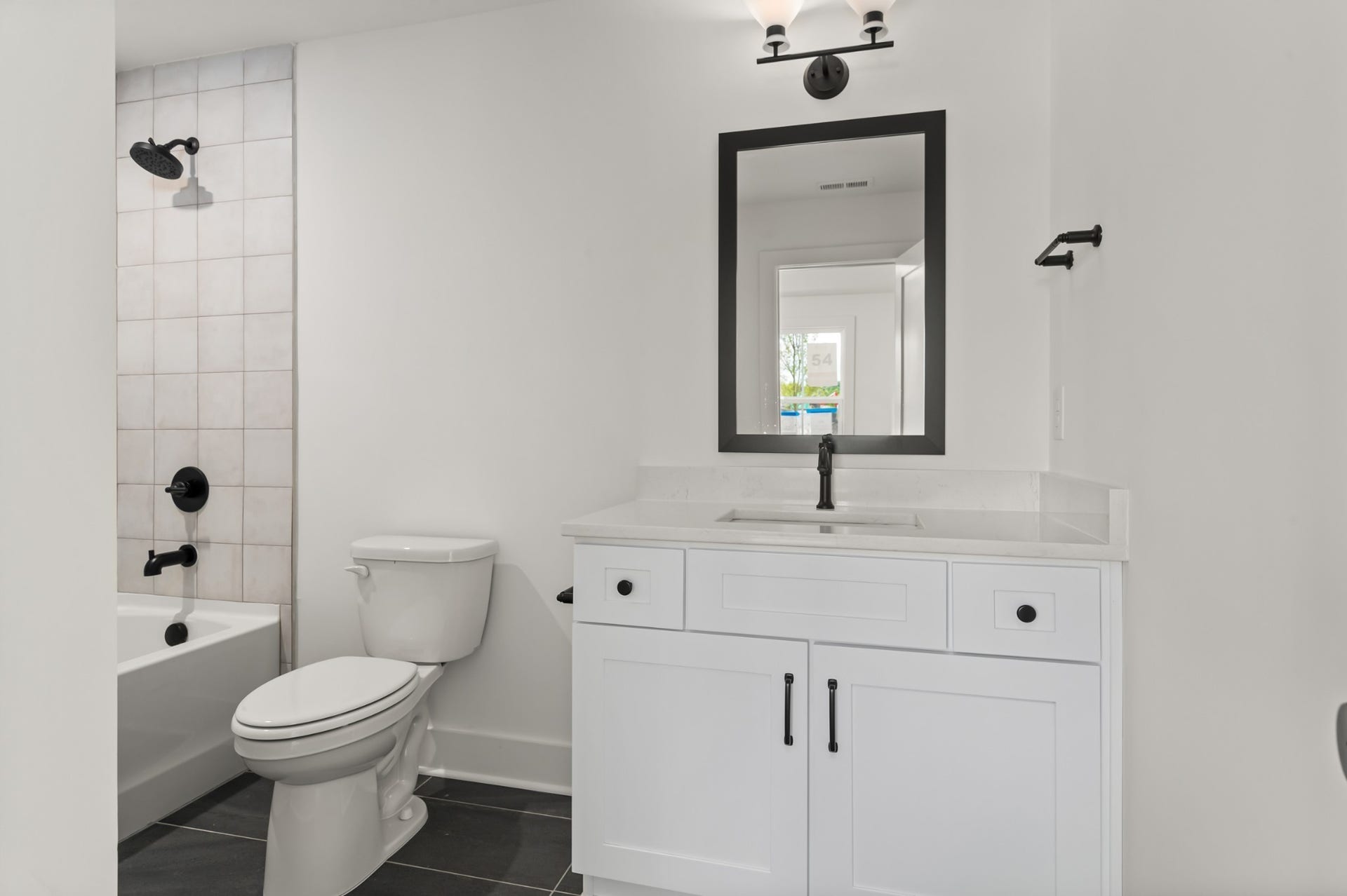 3310 Conviser Dr, Nashville, TN 37207 Your secondary bath features thoughtful design and stylish finishes, providing both convenience and a touch of luxury for family or guests.