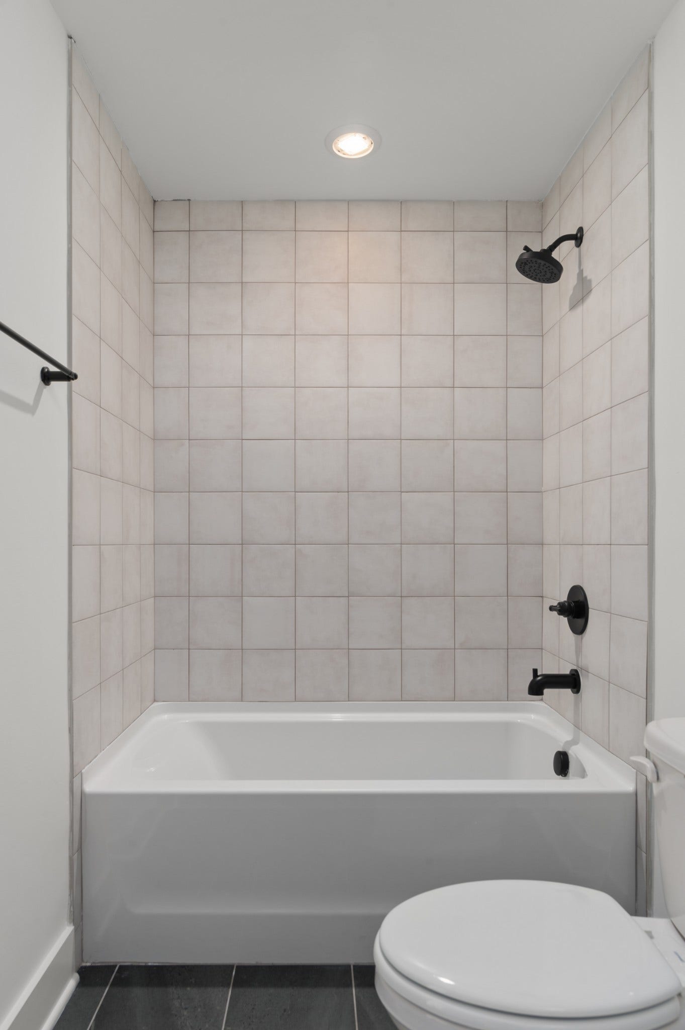 3310 Conviser Dr, Nashville, TN 37207 Indulge in luxury with this beautiful tub, elegantly surrounded by tiles that elevate the design of your bathroom.