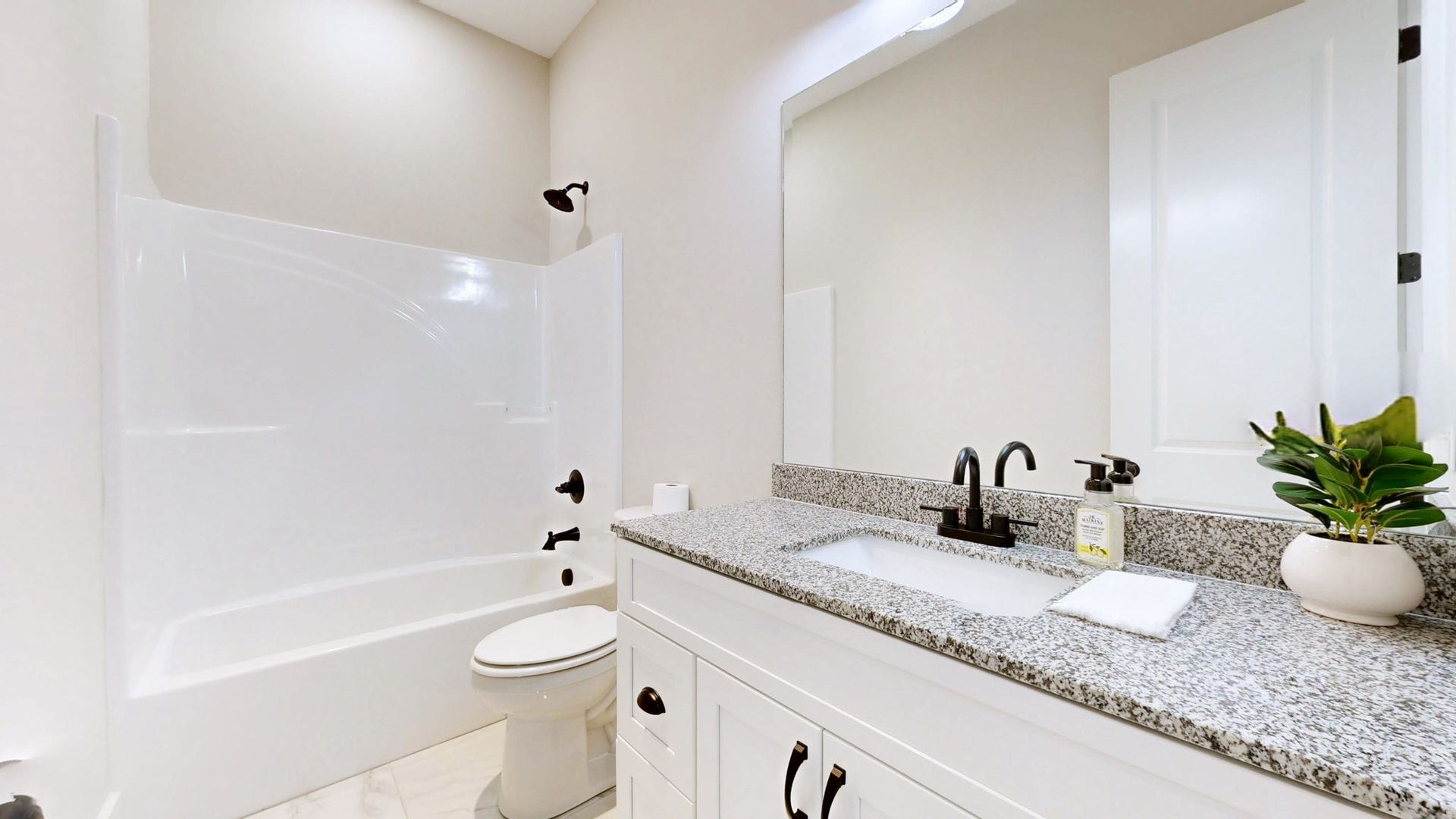 579 Lower Halls Mill Rd, Shelbyville, TN 37160 The guest bathroom features a large vanity, tub/shower combo, and tile floor.
