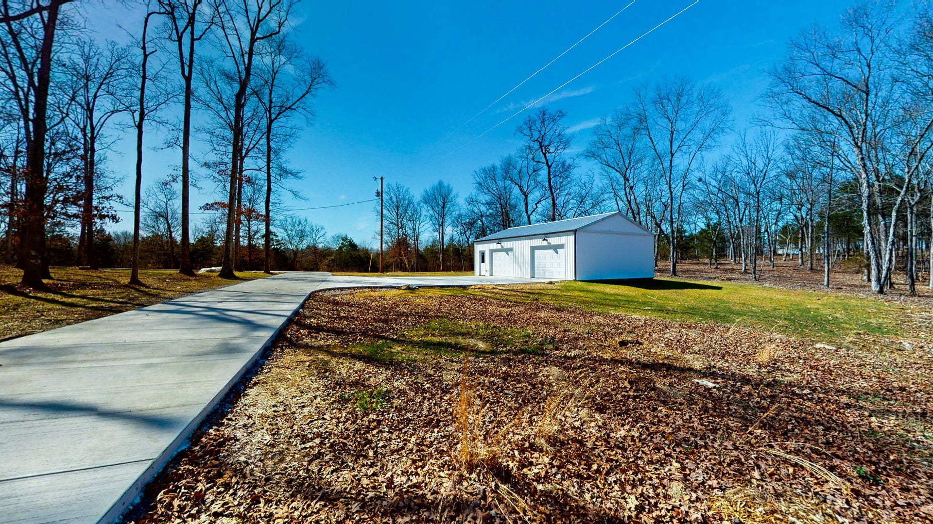 579 Lower Halls Mill Rd, Shelbyville, TN 37160 The long concrete driveway leads to the large two car detached garage a few steps from the house.