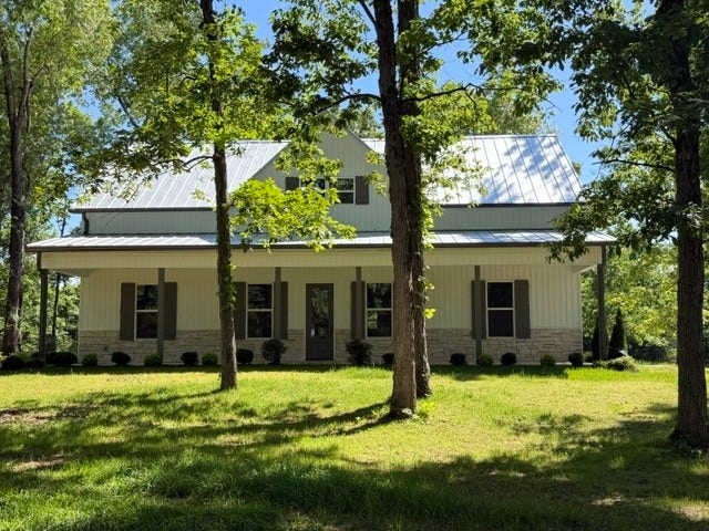 579 Lower Halls Mill Rd, Shelbyville, TN 37160 This gorgeous farmhouse style home is situated on five acres and is within a few minutes of town, but no city taxes! Covered front porch and covered patio in the rear, with solid wood posts.