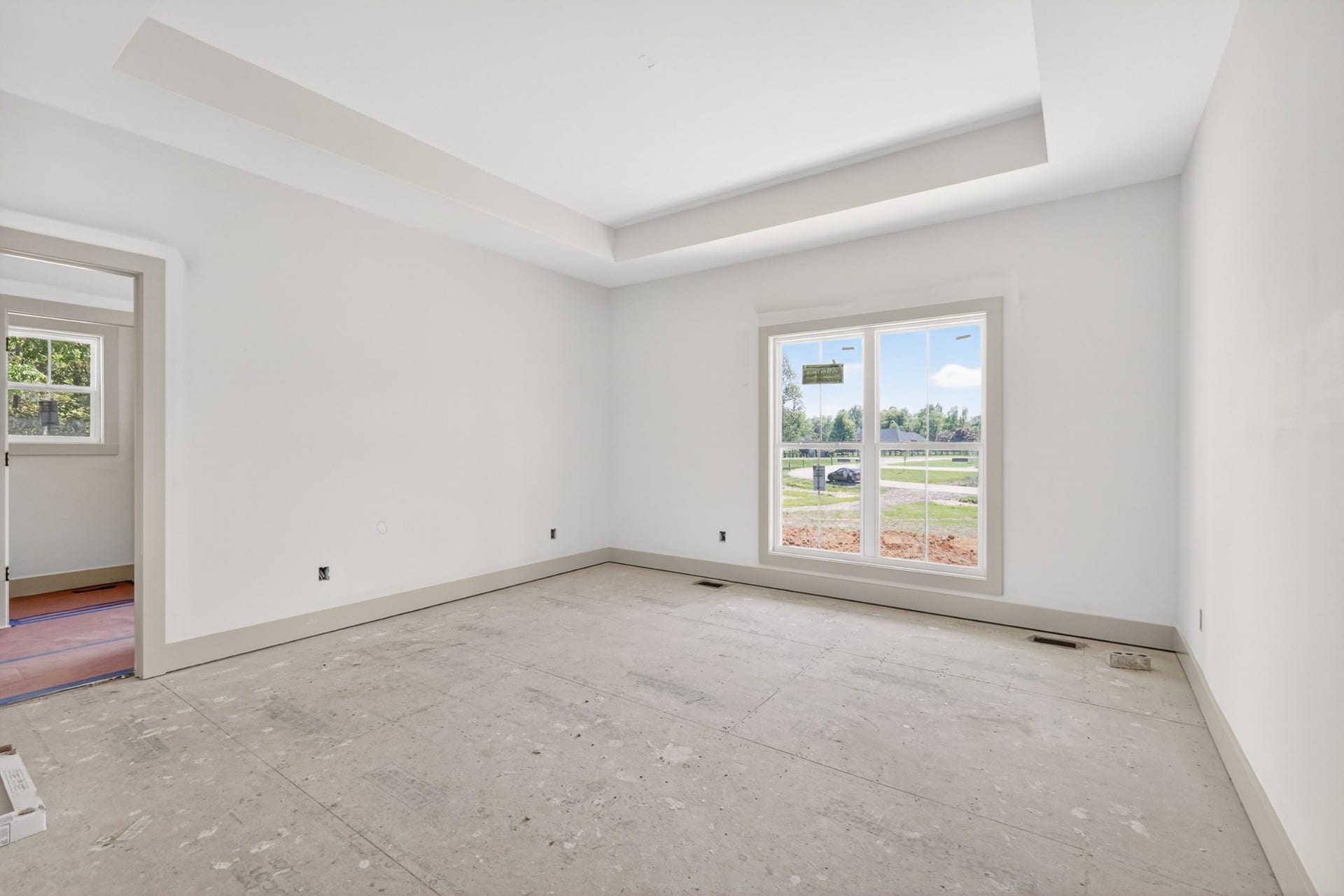 521 Powell Hollow Rd, Shelbyville, TN 37160 Primary bedroom with a trey ceiling and no carpet. The LVP flooring will continue throughout the bedrooms.