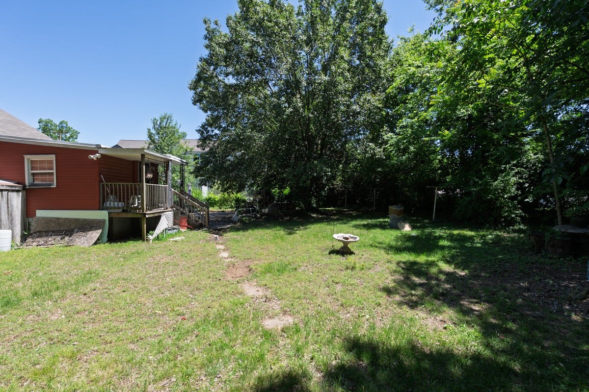 Large back yard with established trees.