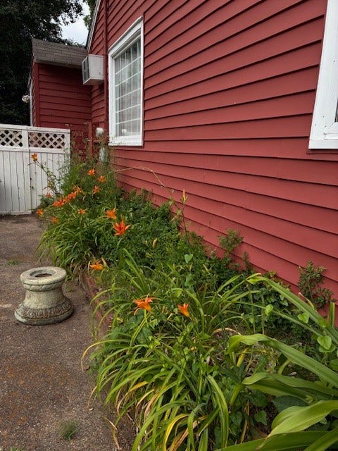 Established flower bed adds color and charm to landscape.