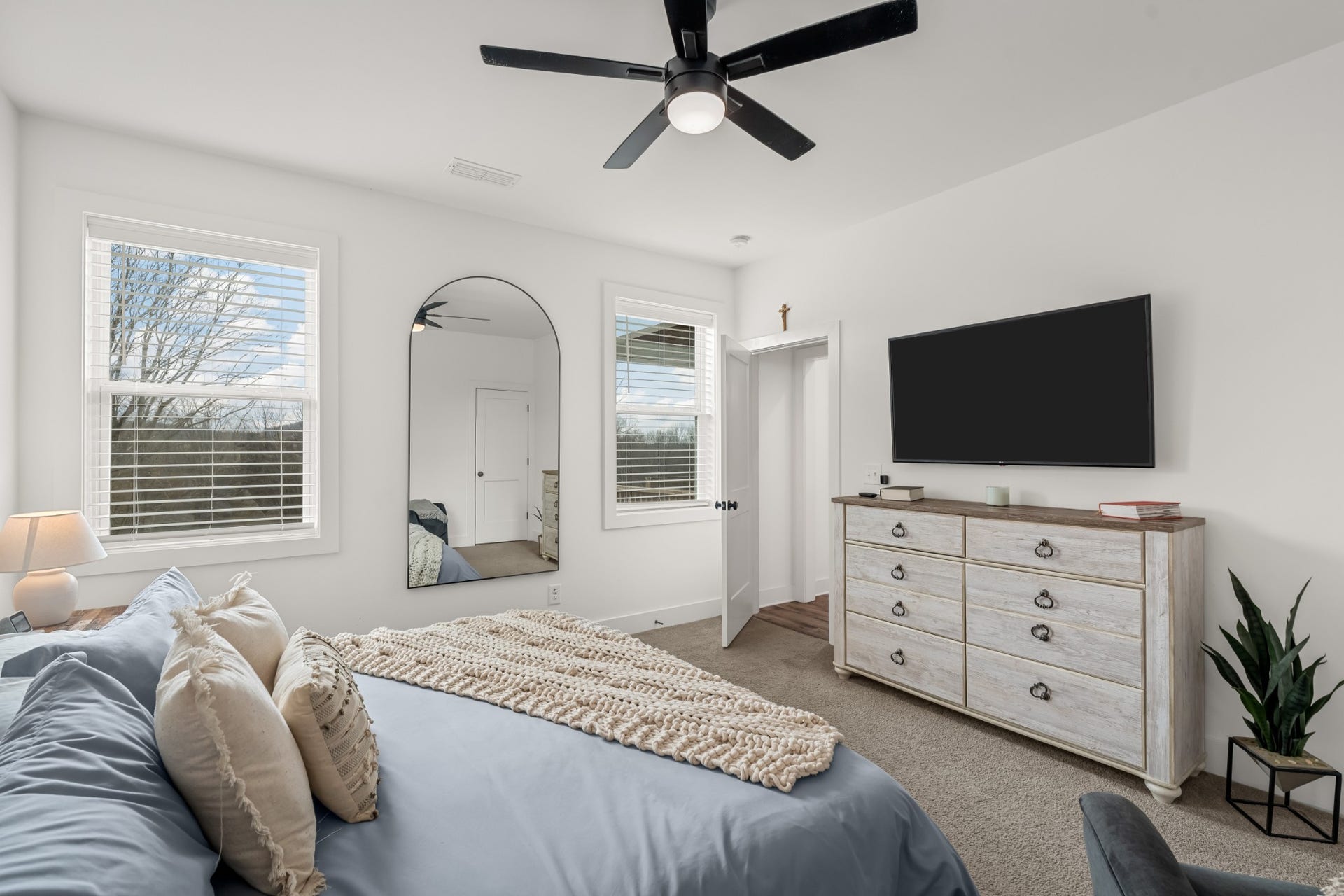 1233 Hartsfield Dr, Columbia, TN 38401 What a nice primary suite with a fan and located off to the side of the home. It has a great walk-in closet and a primary bath attached.