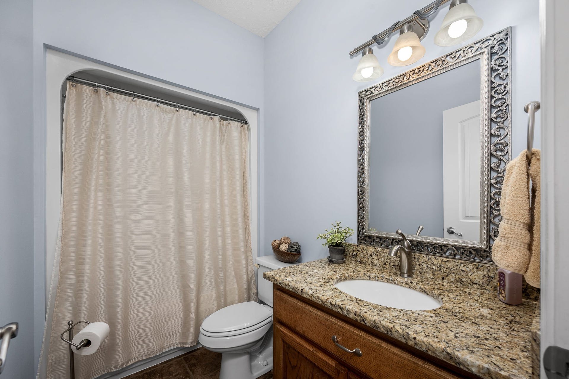 144 Richland Ct, Manchester, TN 37355 The downstairs guest bath has tile flooring, single vanity with granite countertop and a shower/tub combo.