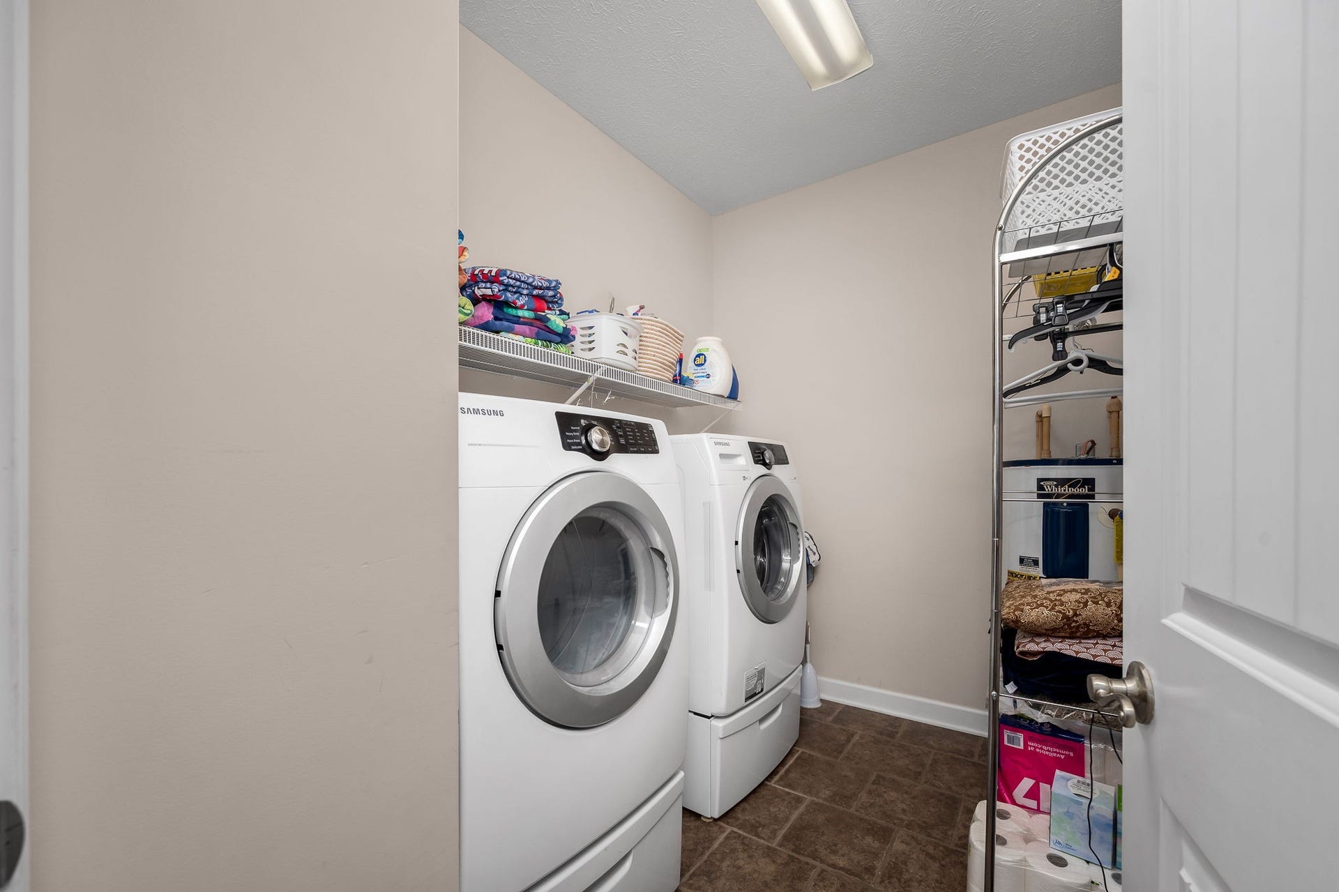 144 Richland Ct, Manchester, TN 37355 Large utility room with tile flooring, shelving and utility sink. (Washer and dryer do not remain.)