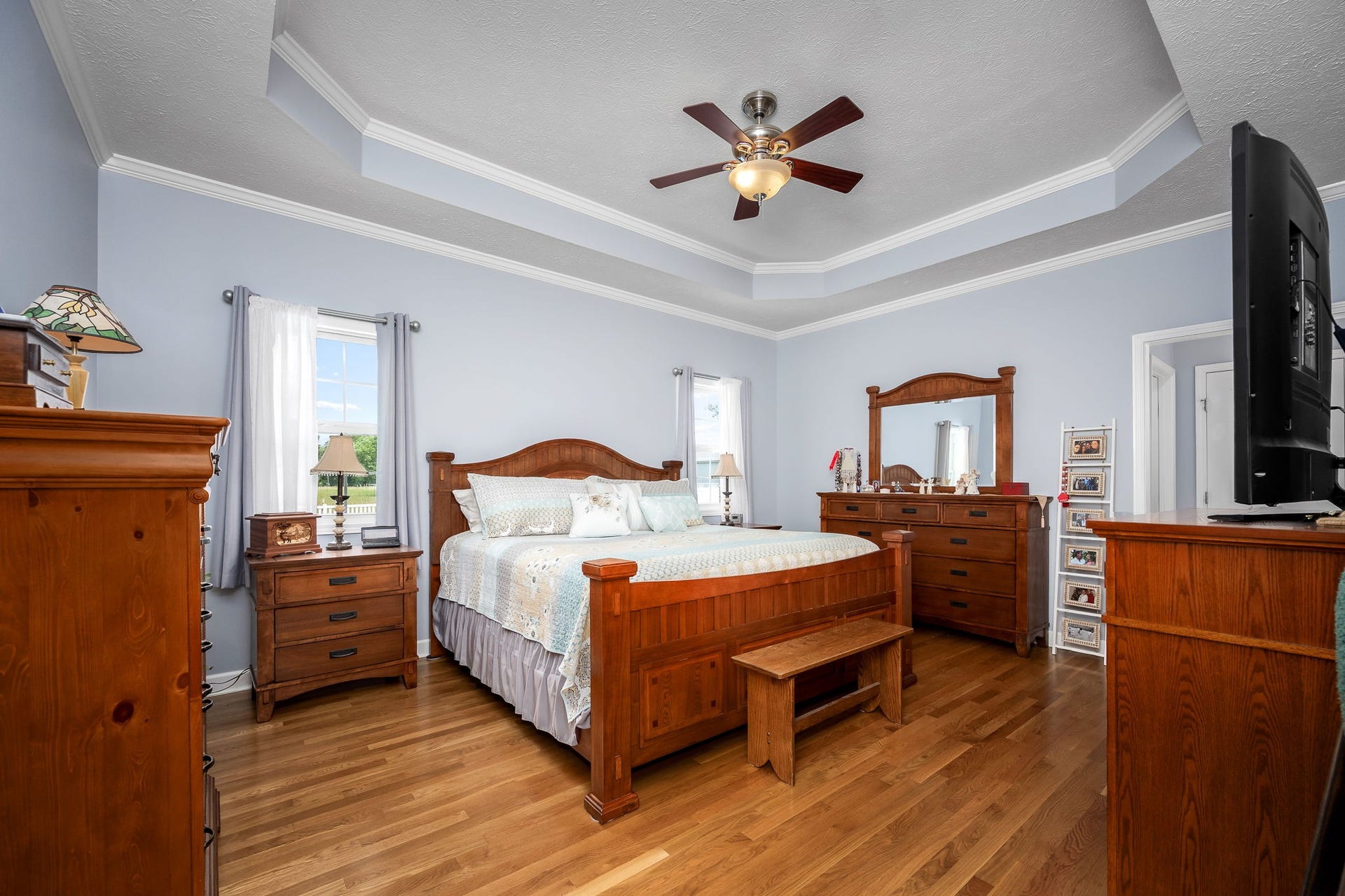 144 Richland Ct, Manchester, TN 37355 Retreat to the huge primary bedroom, adorned with a tray ceiling, and features gleaming hardwood flooring.