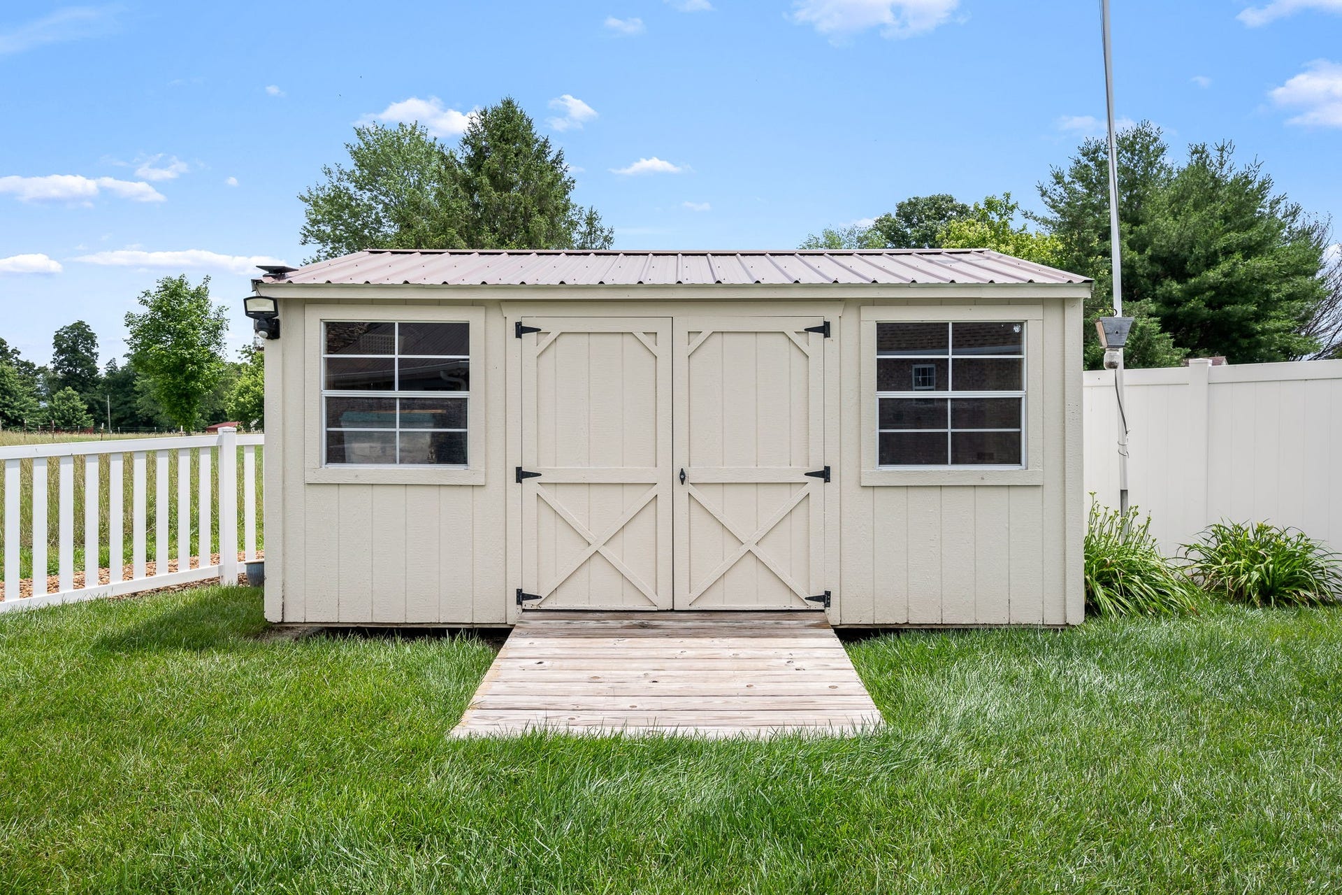 144 Richland Ct, Manchester, TN 37355 Discover the ultimate solution for your storage needs with this beautifully designed storage building located in the serene backyard.