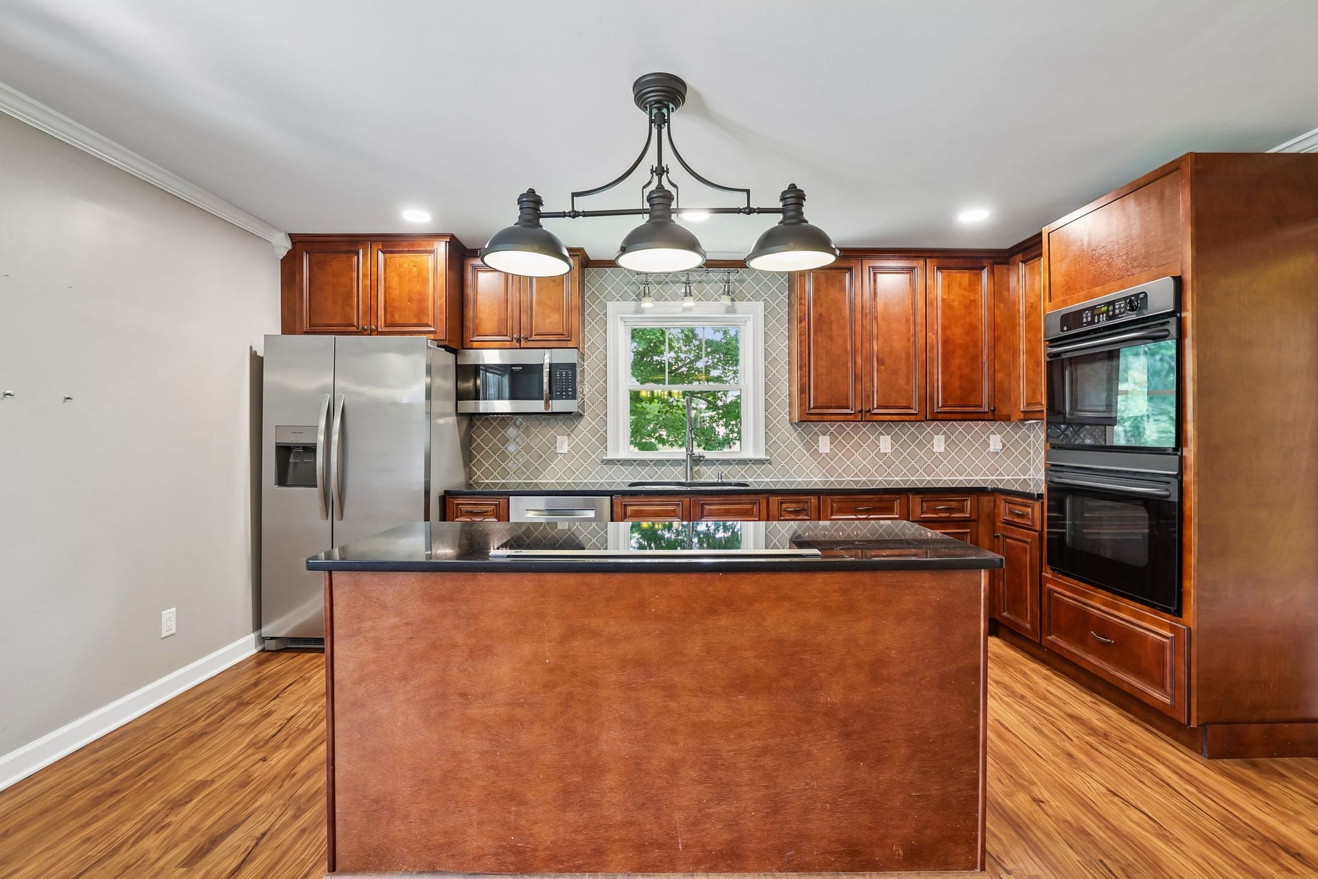 186 Sulphur Springs Rd, Shelbyville, TN 37160 Gorgeous light fixtures, a tiled backsplash and warm toned hardwood flooring melds to create this dreamy kitchen! 186 Sulphur Springs Rd, Shelbyville, TN 37160