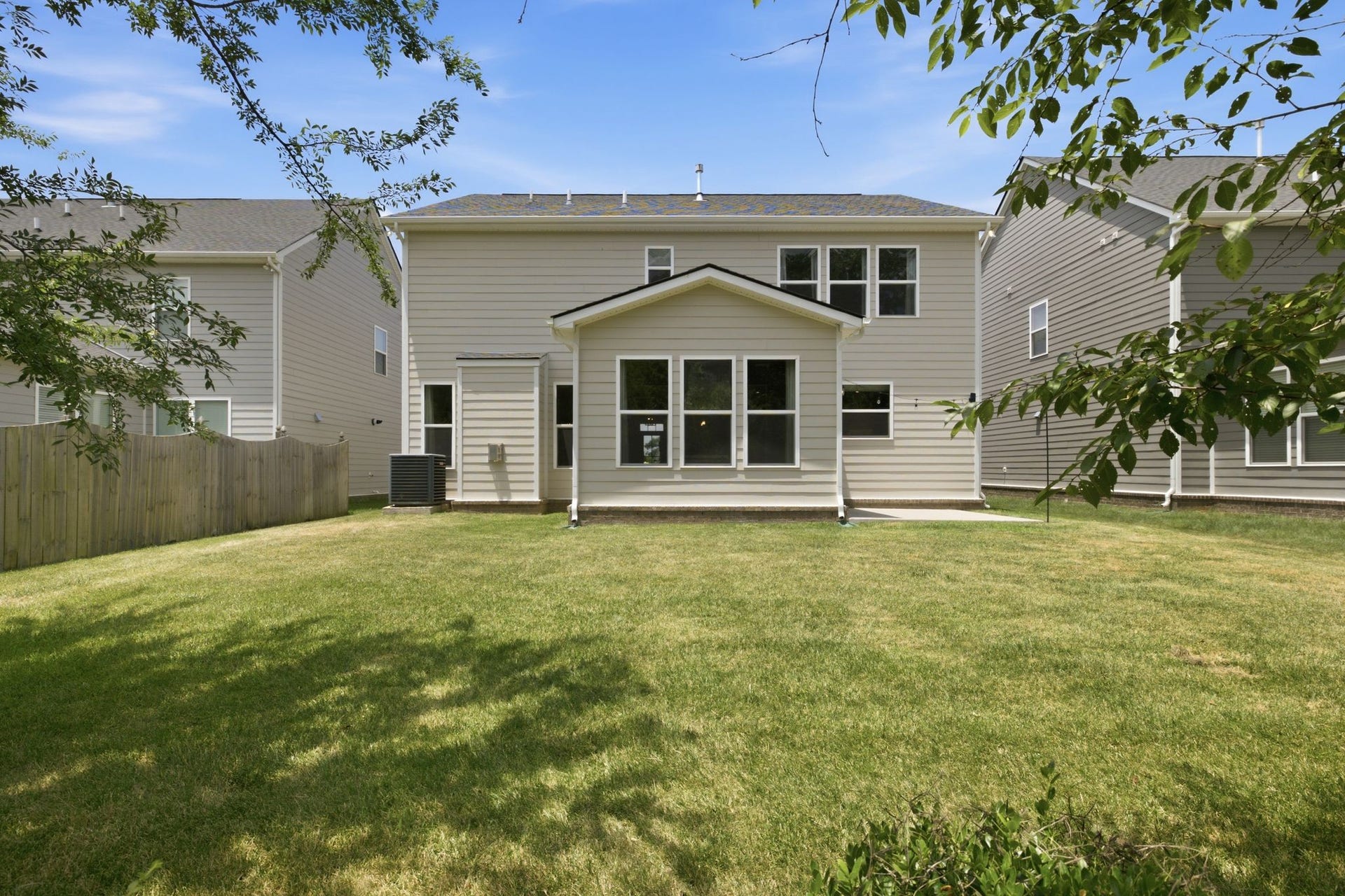 Another view of the home form the back. The sunroom is the most prominent feature in this photo.