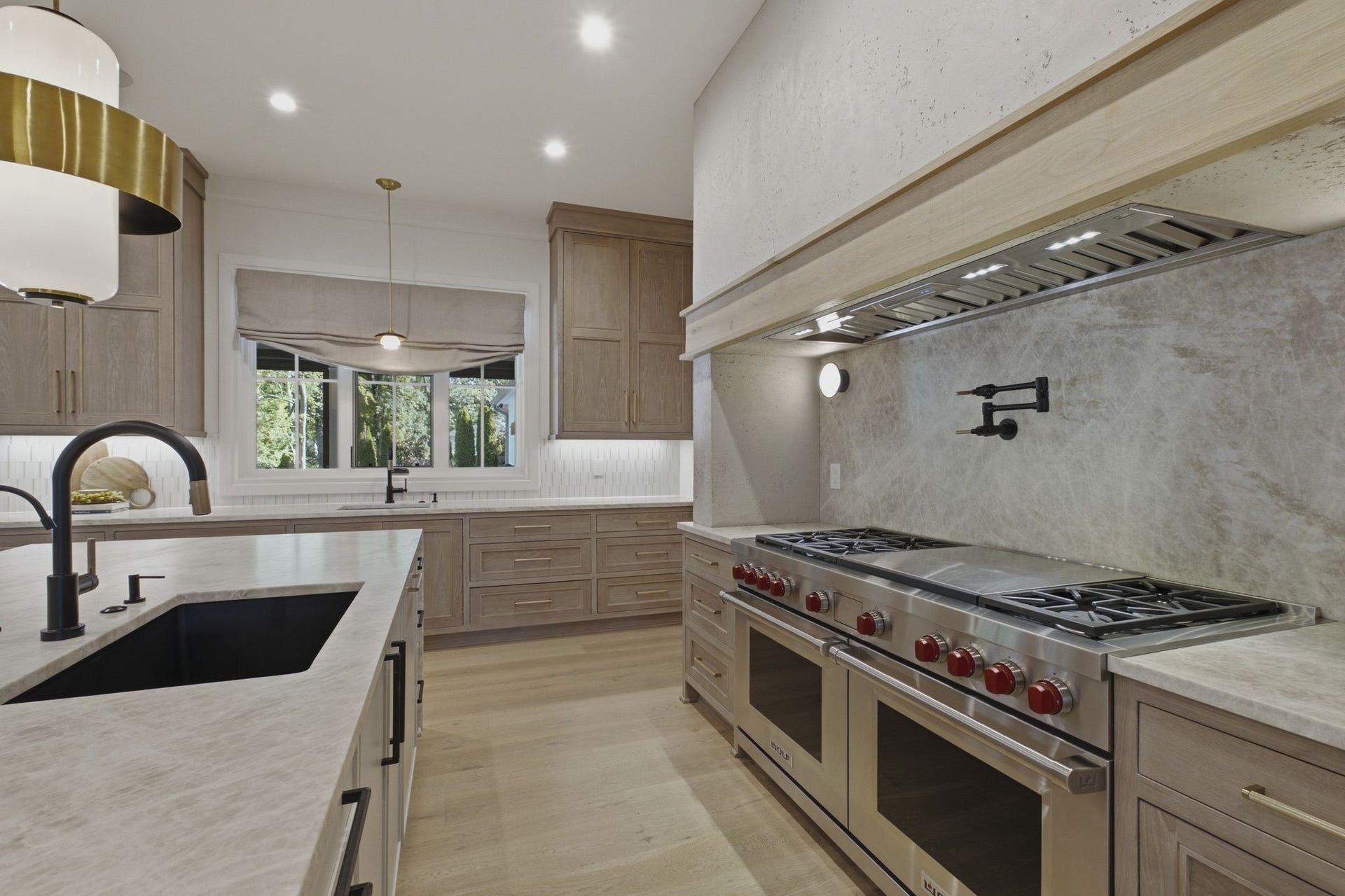 508 Davidson Road, Nashville, TN 37205 Featuring a Wolf double oven gas range with custom vent hood, pot filler, and full-height stone backsplash in the main kitchen.
