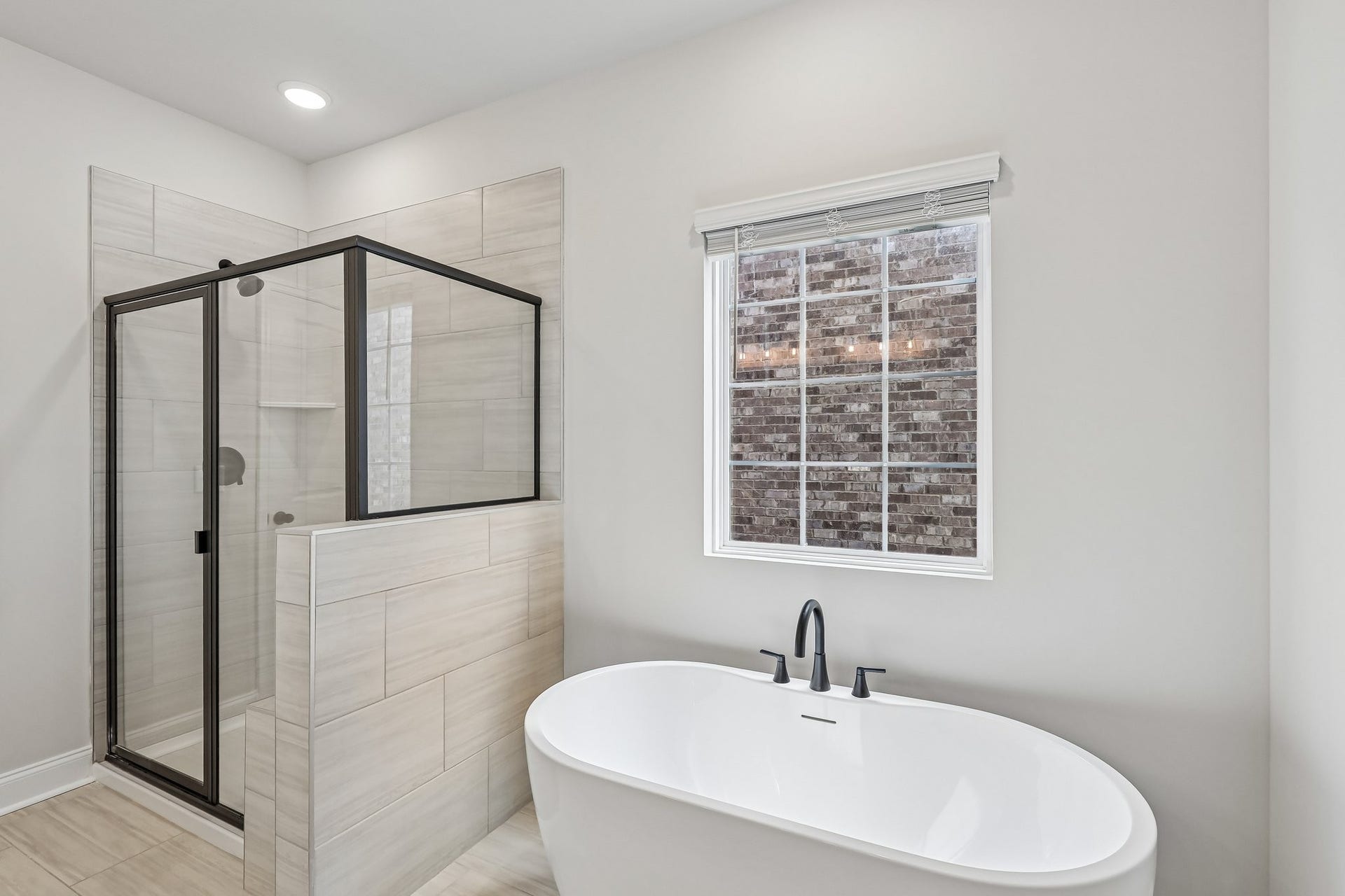 2718 Willowoak Trl, Murfreesboro, TN 37129 ***Home under construction - picture of previously completed townhouse to show layout***
Luxurious primary bath with a spacious shower featuring a built-in bench and a freestanding tub, combining comfort and spa-like elegance.