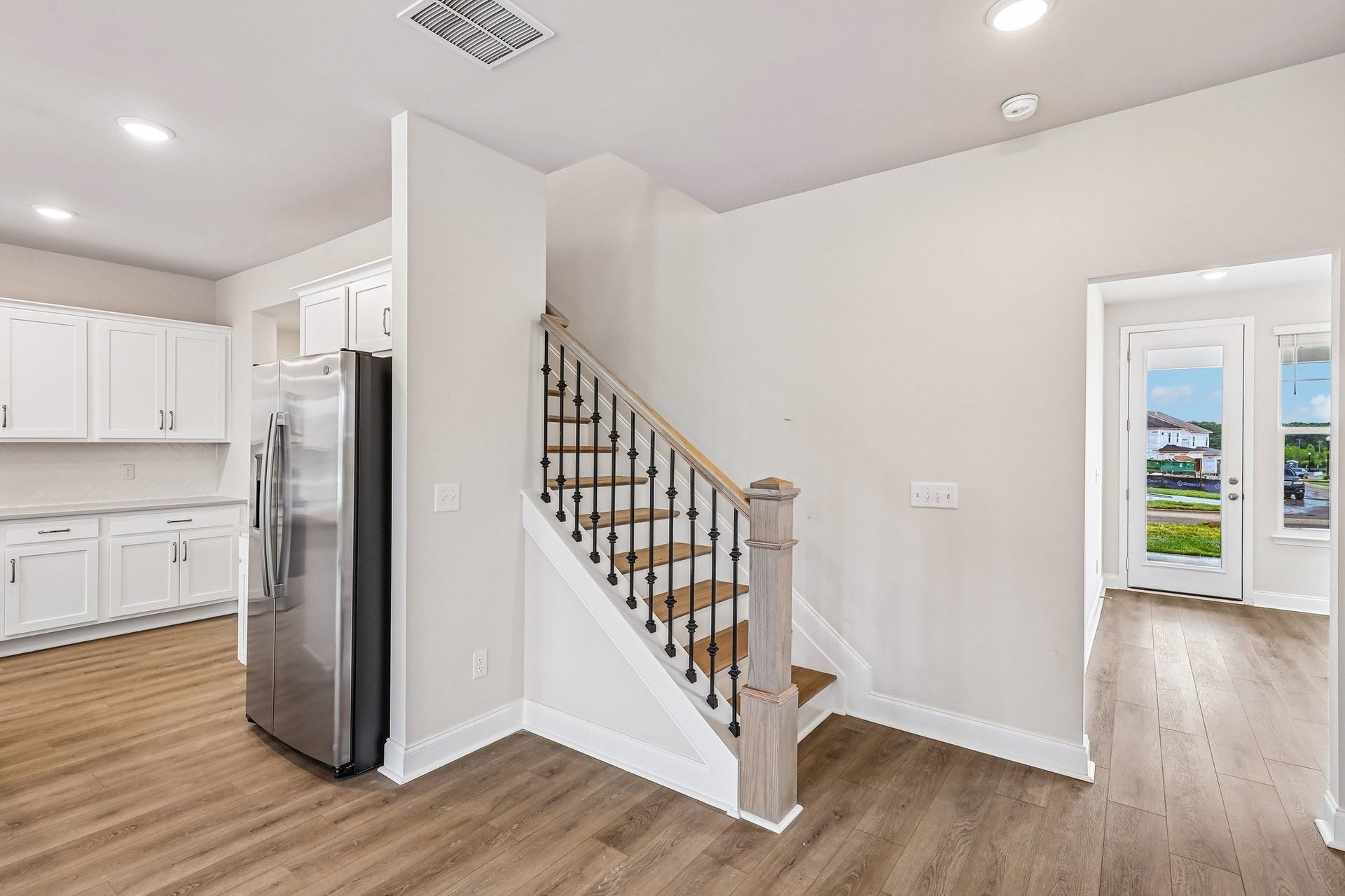 2705 Wilkinson Pike, #2, Murfreesboro, TN 37129 Hardwood stairs with open rail spindles add a touch of warmth and elegance, while luxury vinyl plank (LVP) extends throughout the first level for a cohesive and a durable finish.