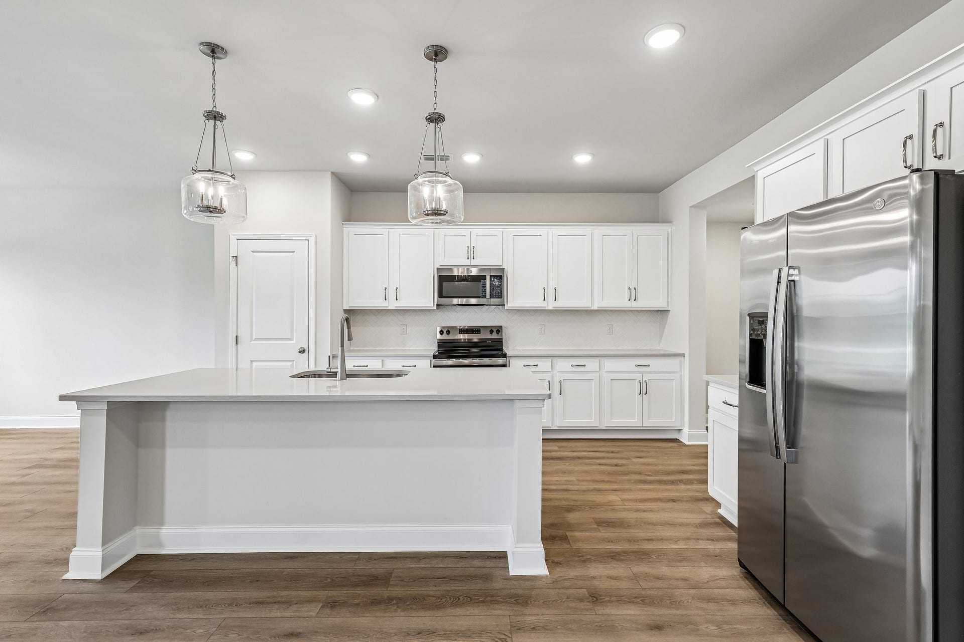 2705 Wilkinson Pike, #2, Murfreesboro, TN 37129 The impressive 7-foot island, topped with sleek quartz countertops, serves as both a stylish focal point and a functional hubperfect for meal prep, casual dining, or gathering with guests.