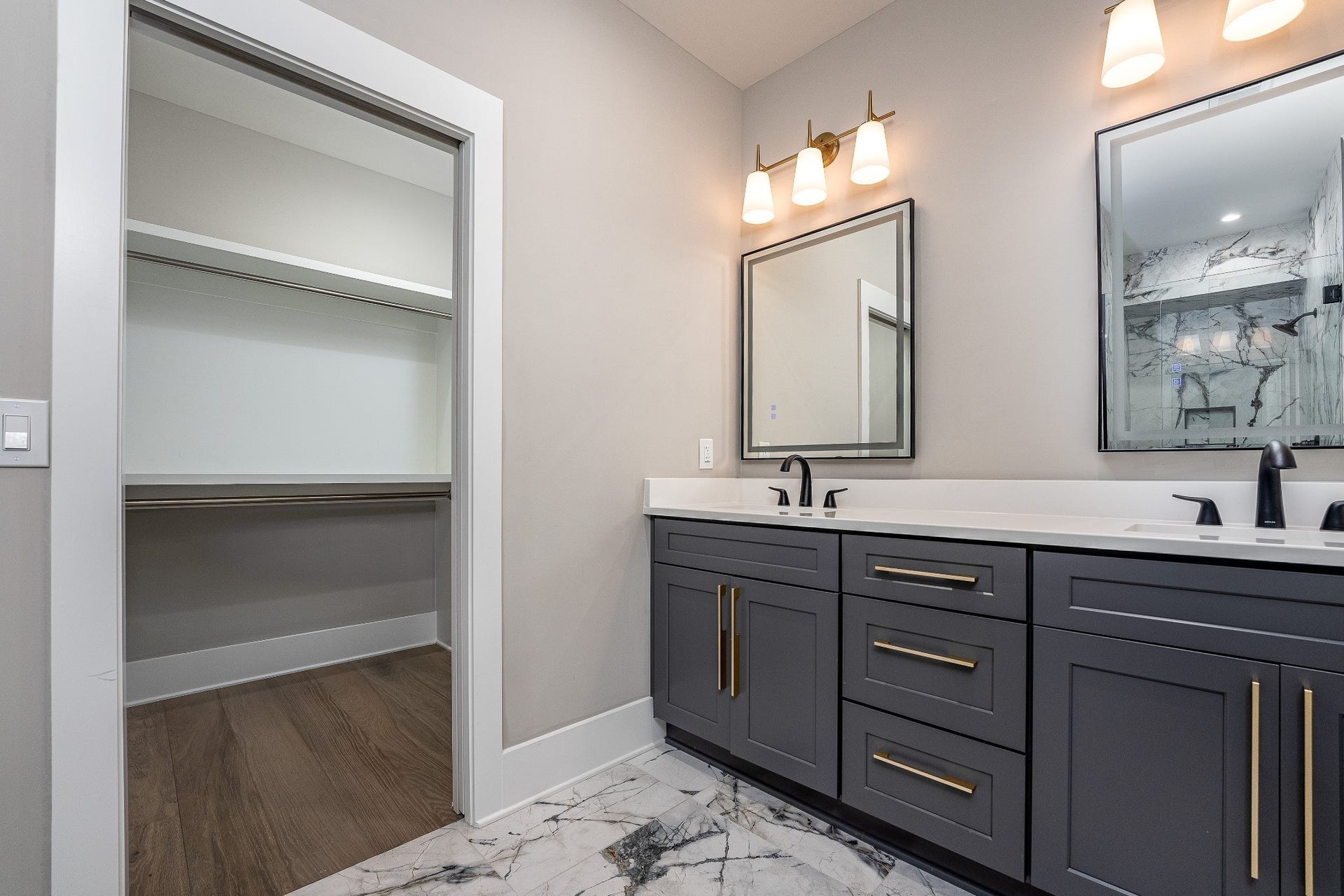 428 E Trinity Ln, #B, Nashville, TN 37207 Primary Bedroom's Ensuite Bathroom featuring Italian Tile Surround Shower and floor with Dual Quartz Vanities with lighted Mirrors and luxury accent lighting sconces. Walk-in Closet.