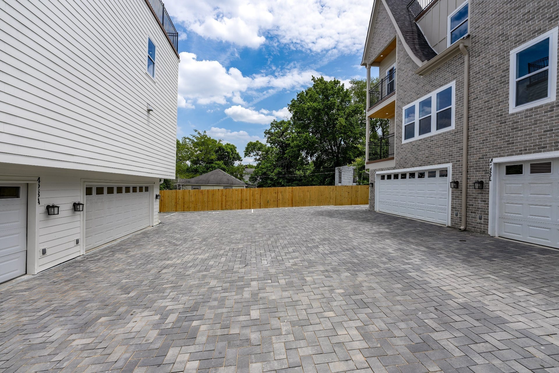 428 E Trinity Ln, #B, Nashville, TN 37207 Courtyard Paved Driveway to private garages of Units A,B,C,D. Complete with 3 side privacy fence around the property.
