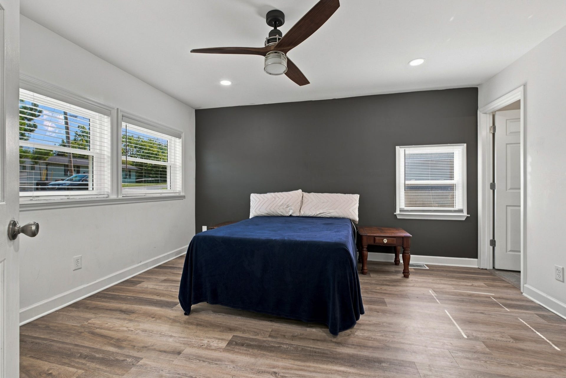 3312 Masonwood Dr, Nashville, TN 37207 The primary bedroom features a stylish accent wall, recessed lighting, and multiple windows that fill the room with natural light.