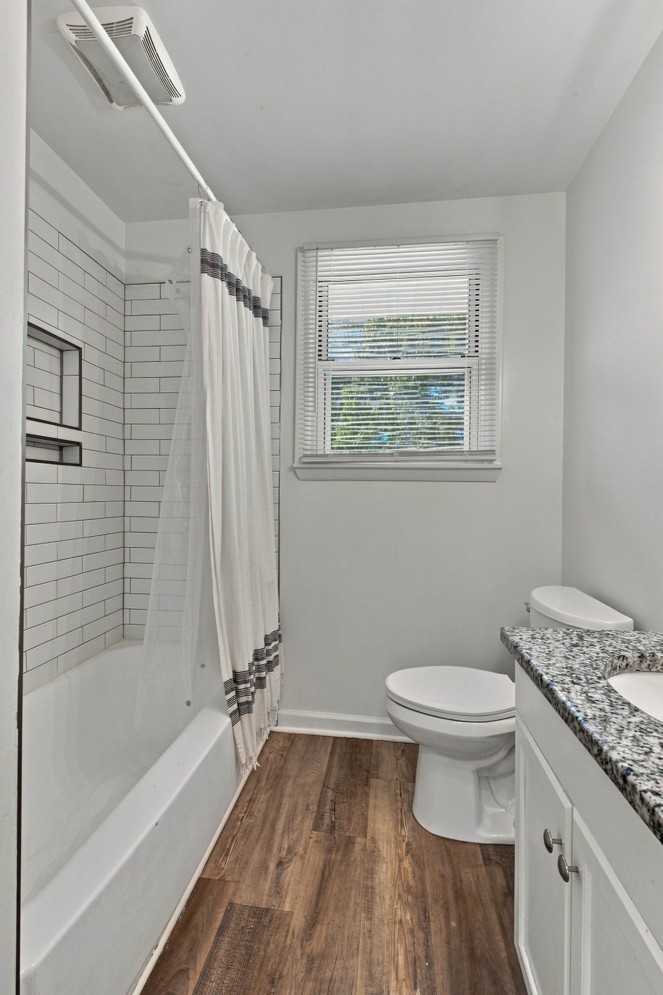 3312 Masonwood Dr, Nashville, TN 37207 The updated hall bath features a granite-topped vanity, timeless subway tile surround, and a bright, fresh design that blends style with everyday functionality.