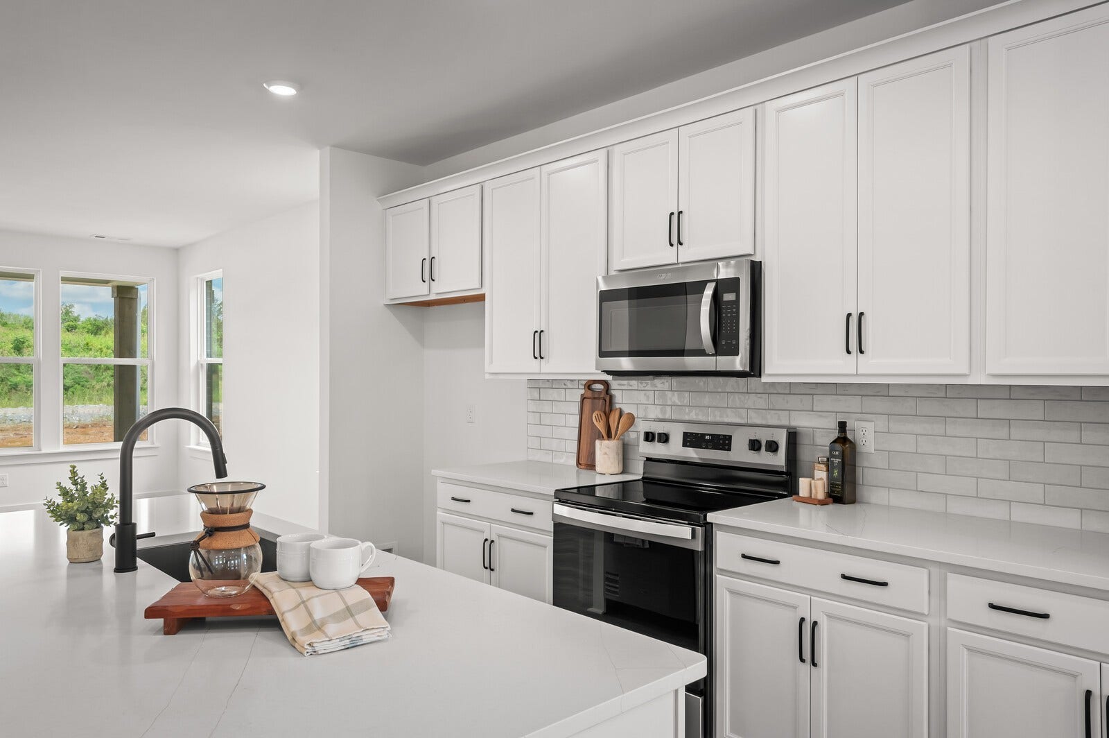 3529 Winterfell Drive, Murfreesboro, TN 37129 Kitchen features timeless white cabinetry, black fixtures, stainless steel appliances, quartz countertops, and a gorgeous tile backsplash!