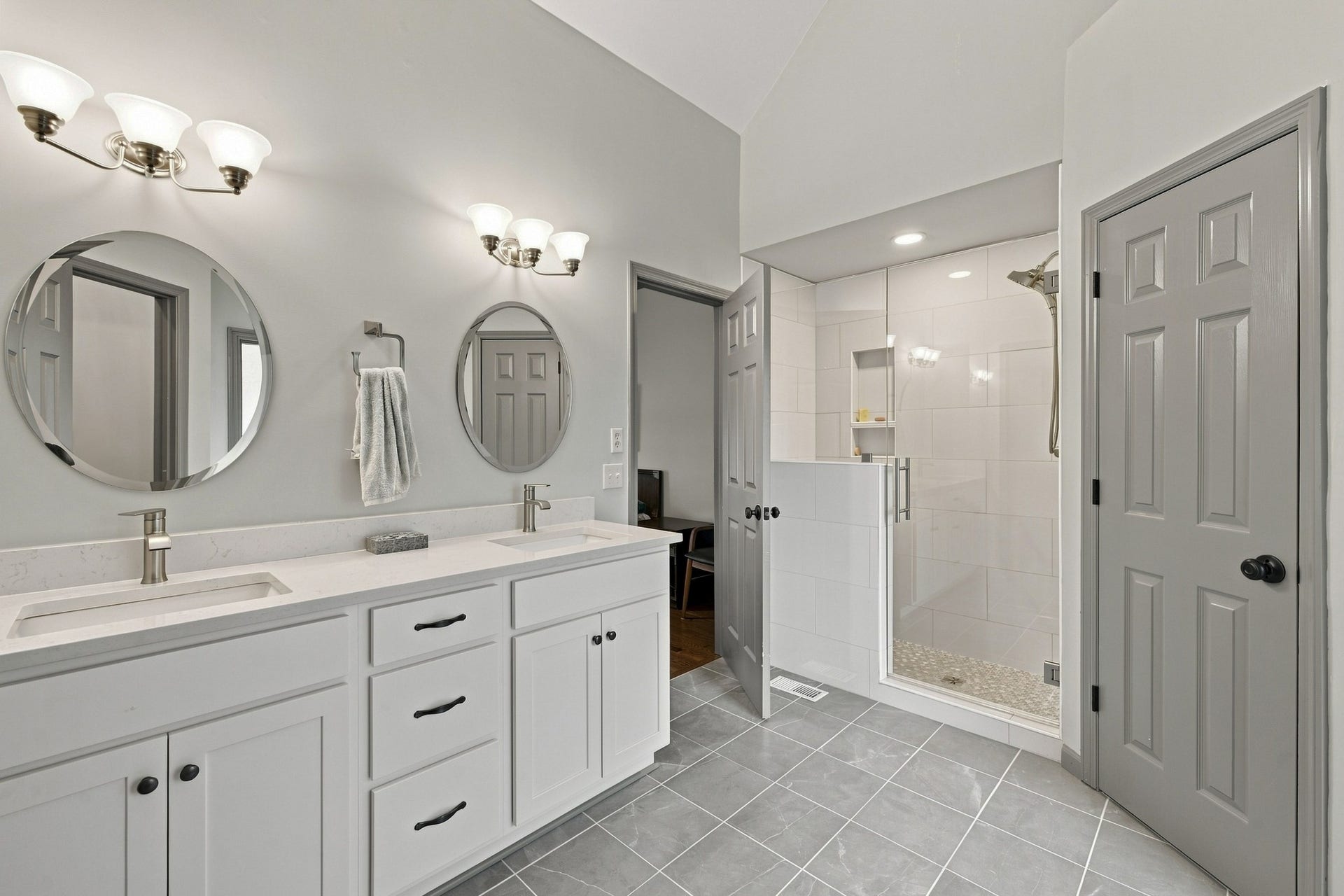 830 Banner Dr, Murfreesboro, TN 37129 Primary bathroom suite on first floor, updated with elegant tile floors, large tile shower, double vanity, soaker tub, and his and hers closets.