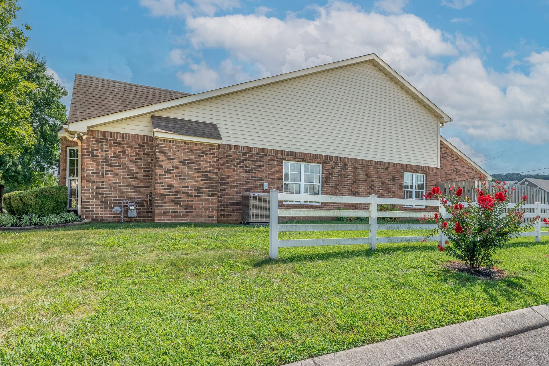 1300 Crofton Park Ct, Columbia, TN 38401 Side yard show white board fence and plenty of green space.
