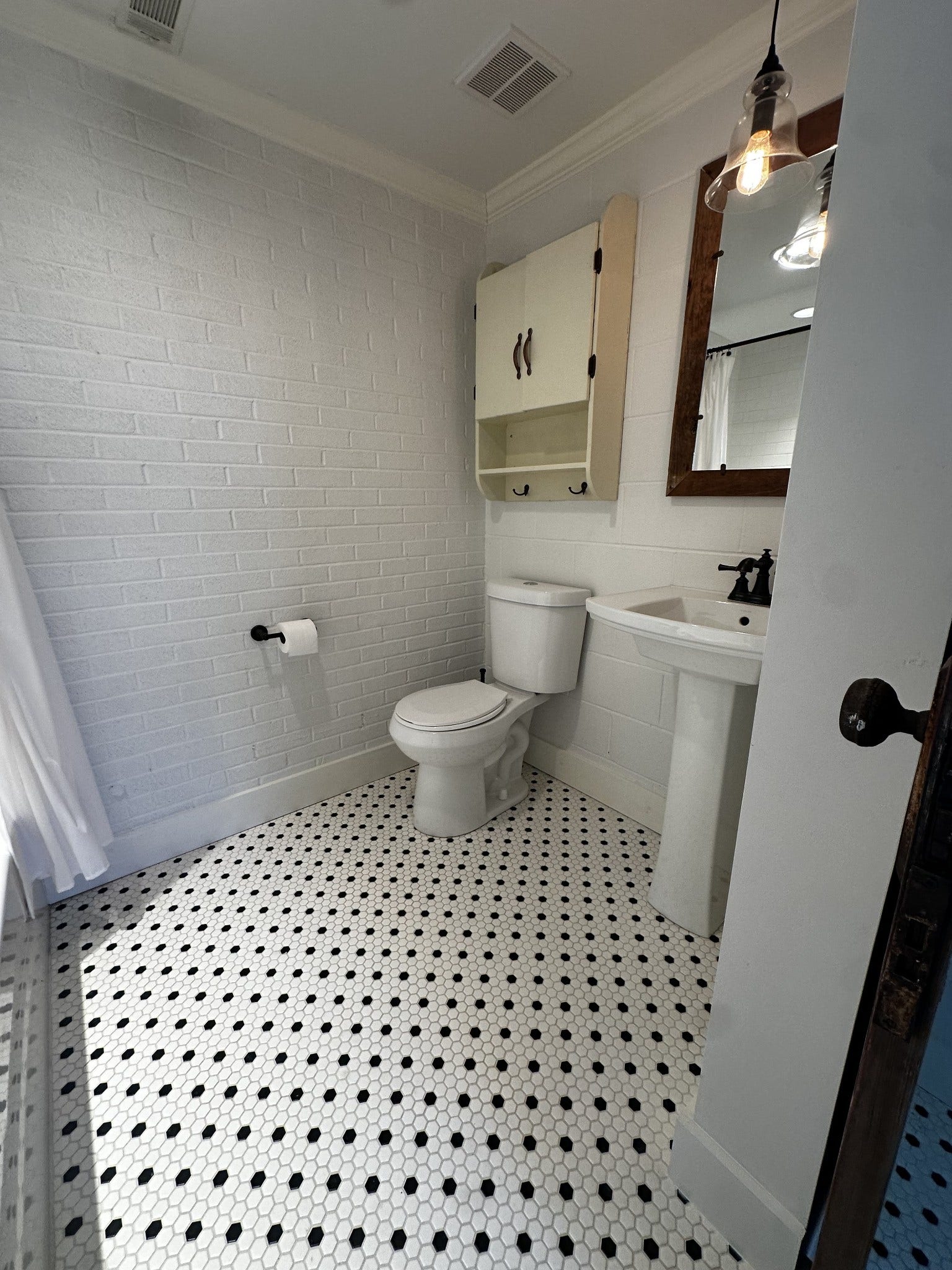 2930 Murfreesboro Hwy, Manchester, TN 37355 2nd bath with gorgeous tile, kohler pedestal sink, mirror framed with reclaimed barn wood and tub/shower combo