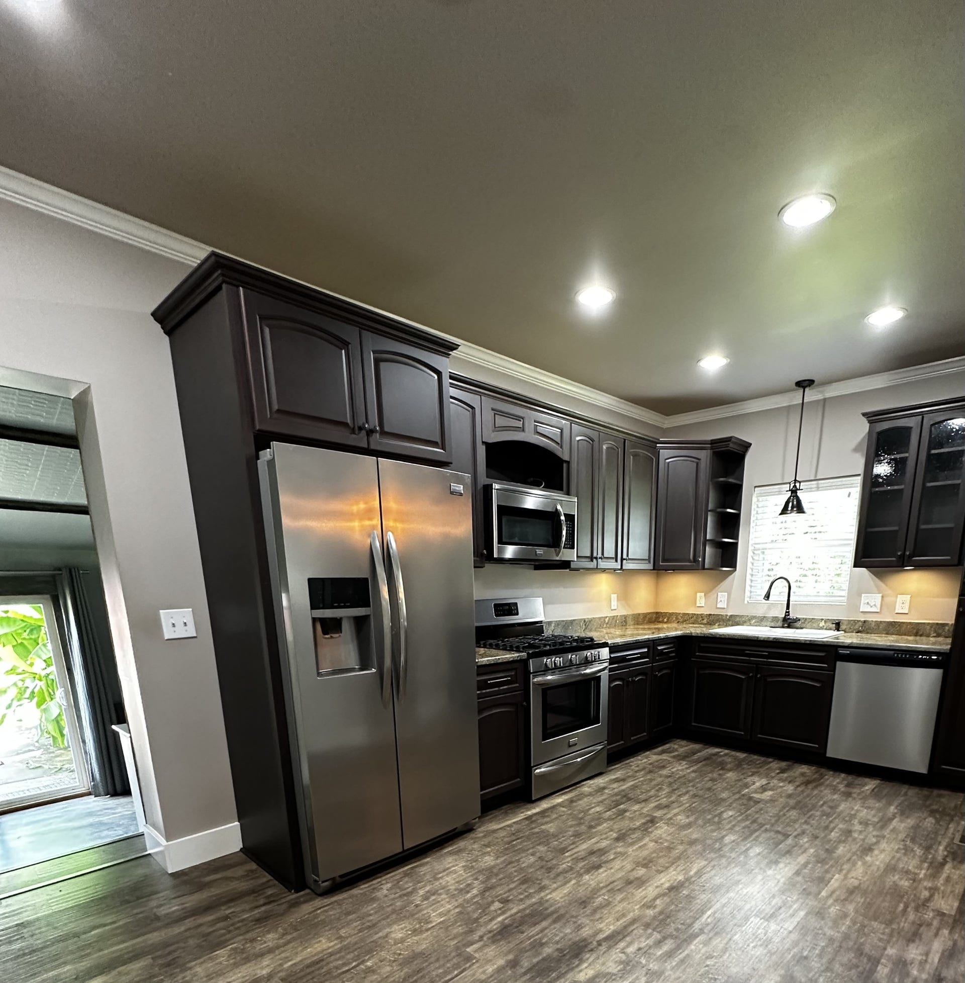 2930 Murfreesboro Hwy, Manchester, TN 37355 Remodeled kitchen with newer all soft close cabinets, stainless steel appliances, dishwasher, garbage disposal, under counter lighting, gas cooktop, electric oven, microwave, fridge with water and ice in door, and granite countertops