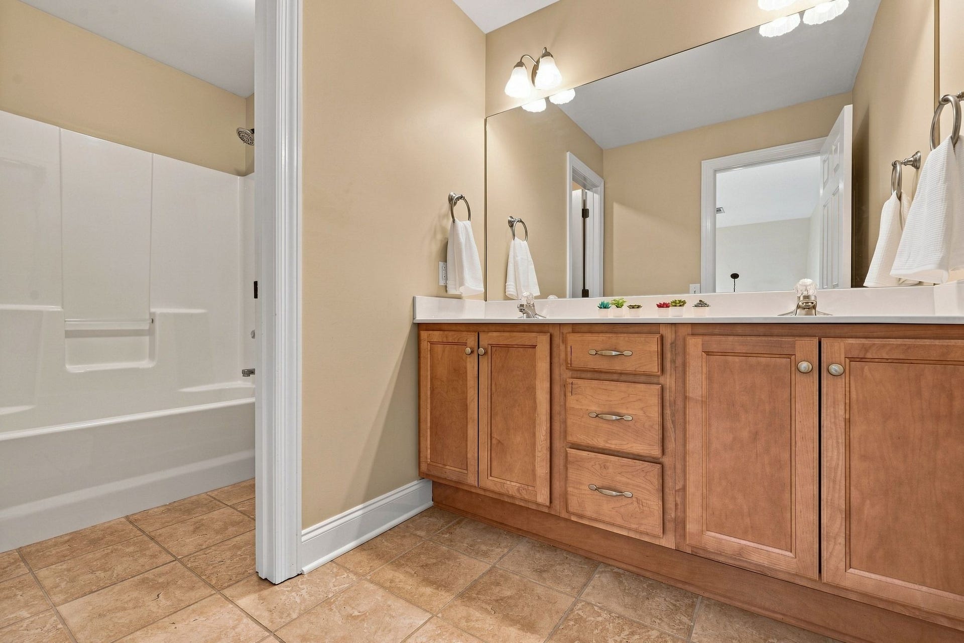 2153 Aberdeen Cir, Murfreesboro, TN 37130 The full upstairs bath is built for sharing, with a double vanity and a privacy door separating the sinks from the shower.