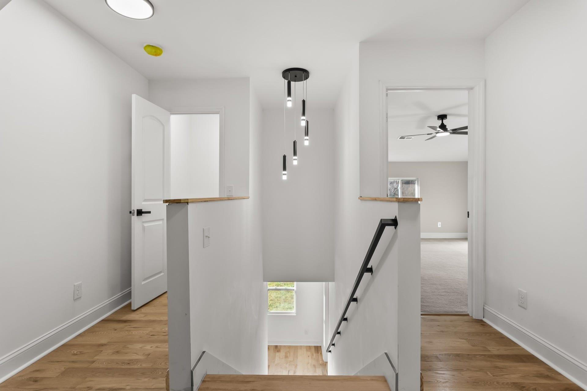 View from the top of the stairs, extra hall closet for storage and view of bedoom 4