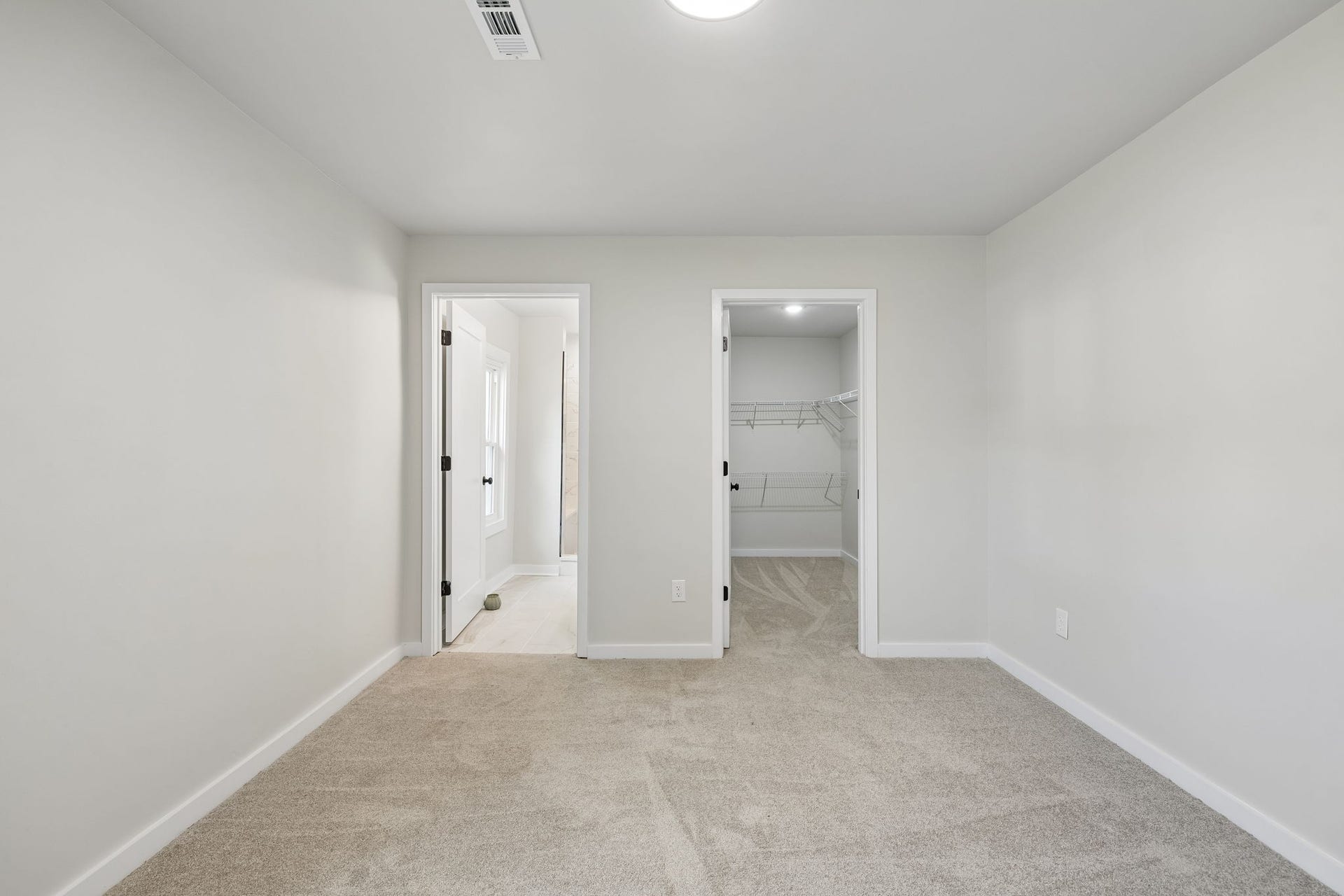 209 Olive St, Mount Pleasant, TN 38474 Large walk in closet with new carpet and full bathroom makes this a perfect primary suite.