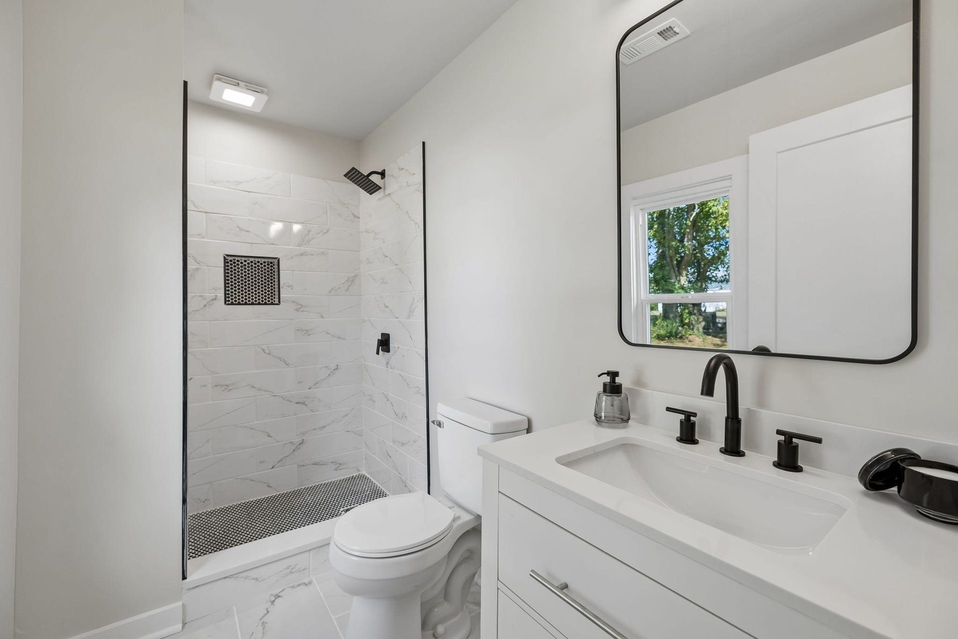 209 Olive St, Mount Pleasant, TN 38474 Full bath off of bedroom 1 with tile shower and all new tile floor and vanity.
