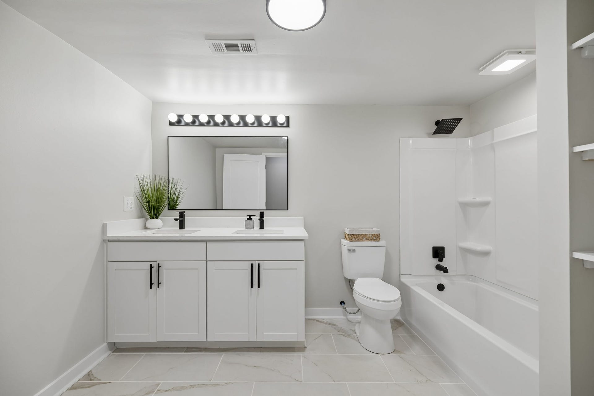 209 Olive St, Mount Pleasant, TN 38474 Large hallway bath with new vanity, tile floors, all new fixtures and linen storage.