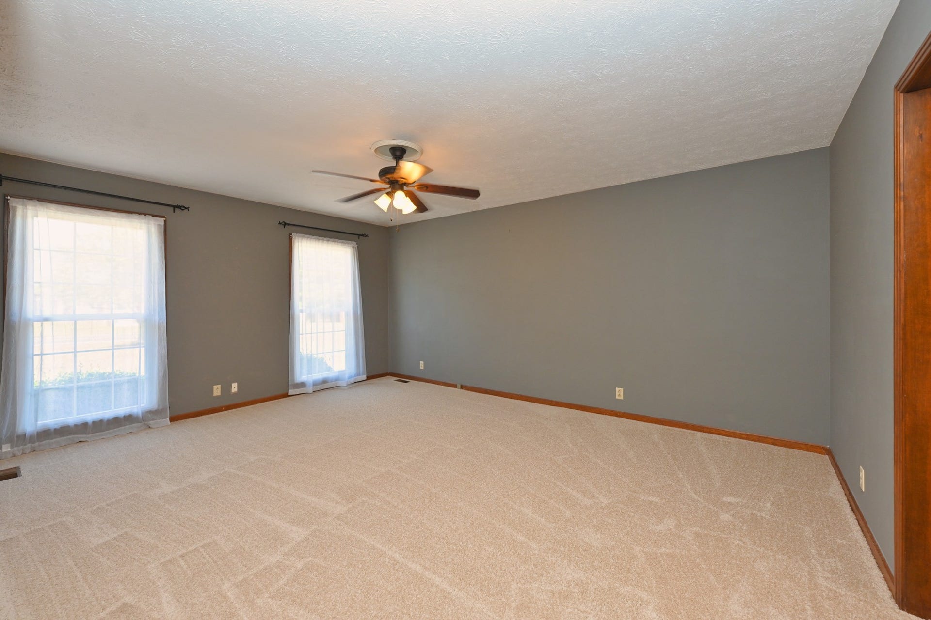 spacious primary suite with plenty of natural lighting