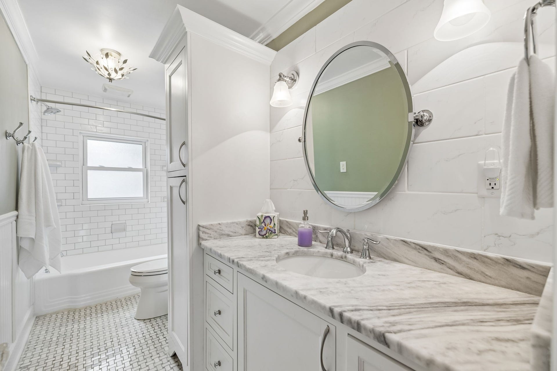 Timeless, fresh, and thoughtfully finished. The beautifully renovated bathroom pairs crisp white finishes with high end quartz surfaces and classic tile for a space that feels both clean and inviting.