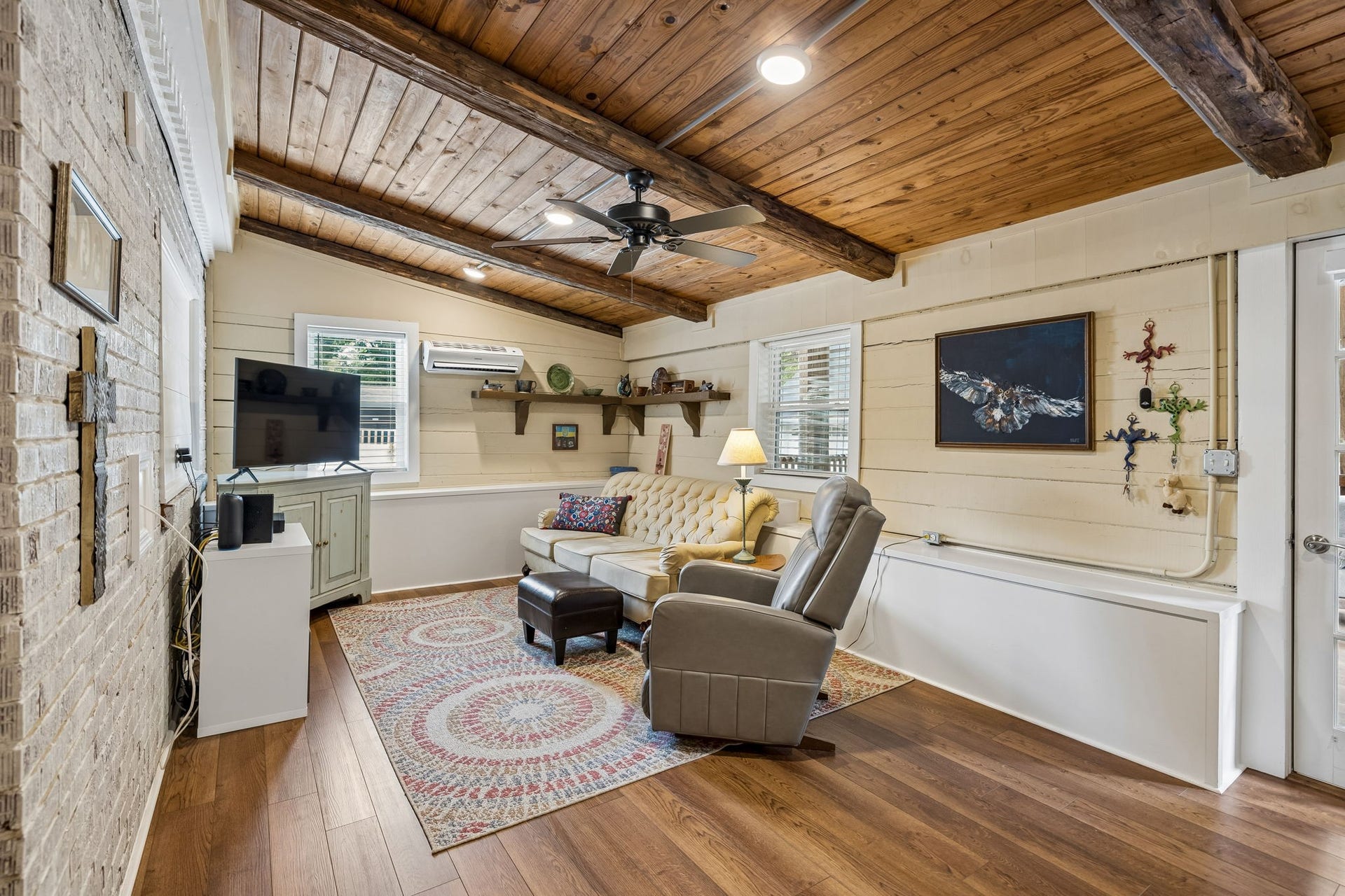 A room with a little history and a lot of personality. Whether it becomes movie night central, a reading room, or a place to gather with friends, this space invites you to make it your own.