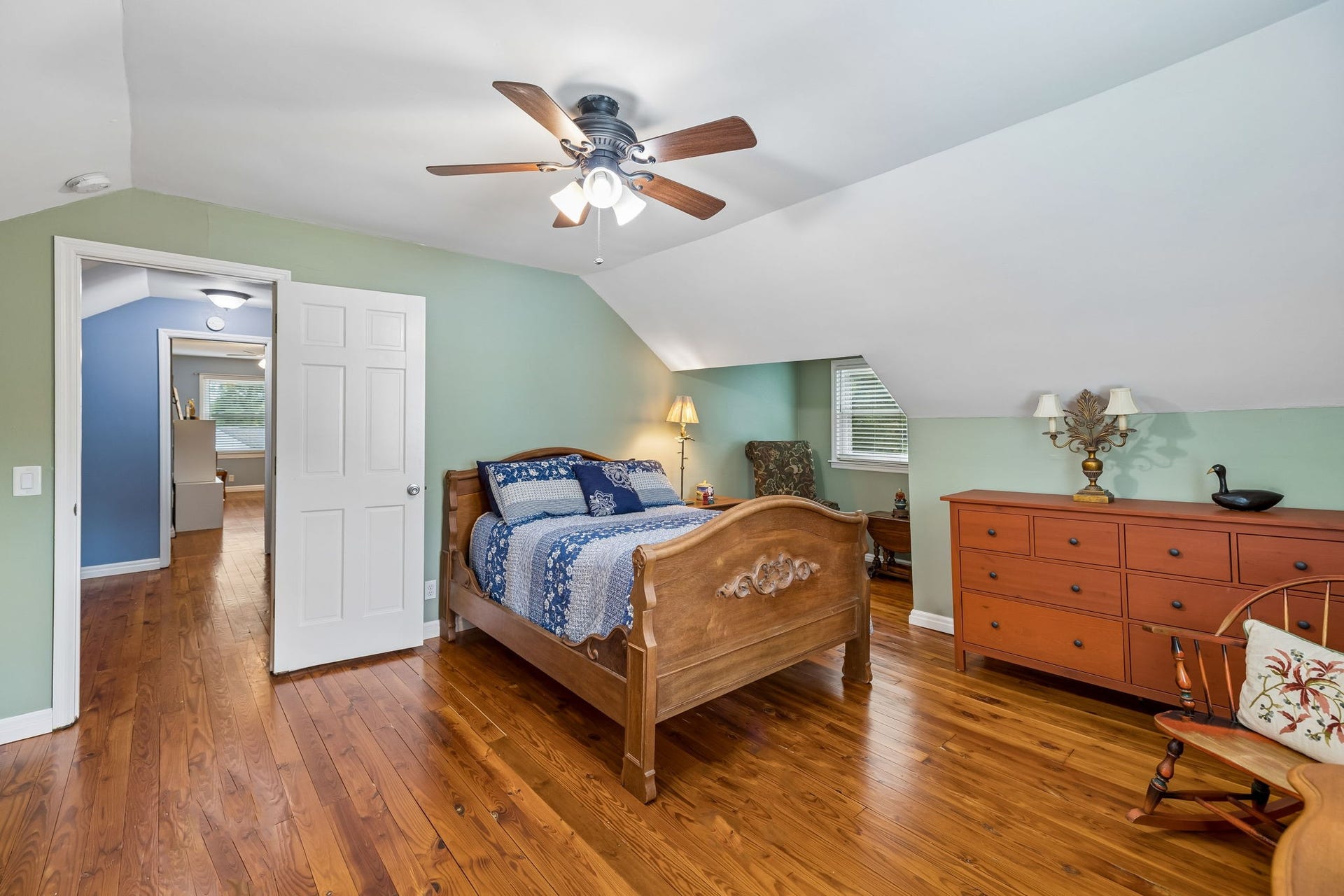 Theres room here for more than just a bed. With generous floor space, multiple windows, and charming architectural lines from the roof, this room offers plenty of flexibility for a sitting area, reading nook, or workspace.