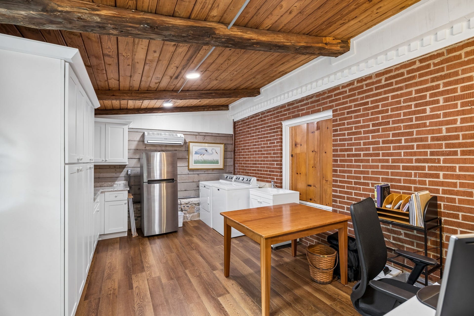 And this is the kind of laundry room you dont often find in a home with this much character. Oversized and incredibly functional, theres room for laundry, storage, a workspace, and all the everyday extraswhile the exposed beams, wood ceiling, and