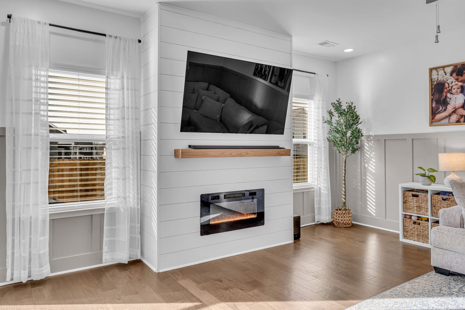 In the large living room, the sellers added this custom electric fireplace with shiplap surround.
