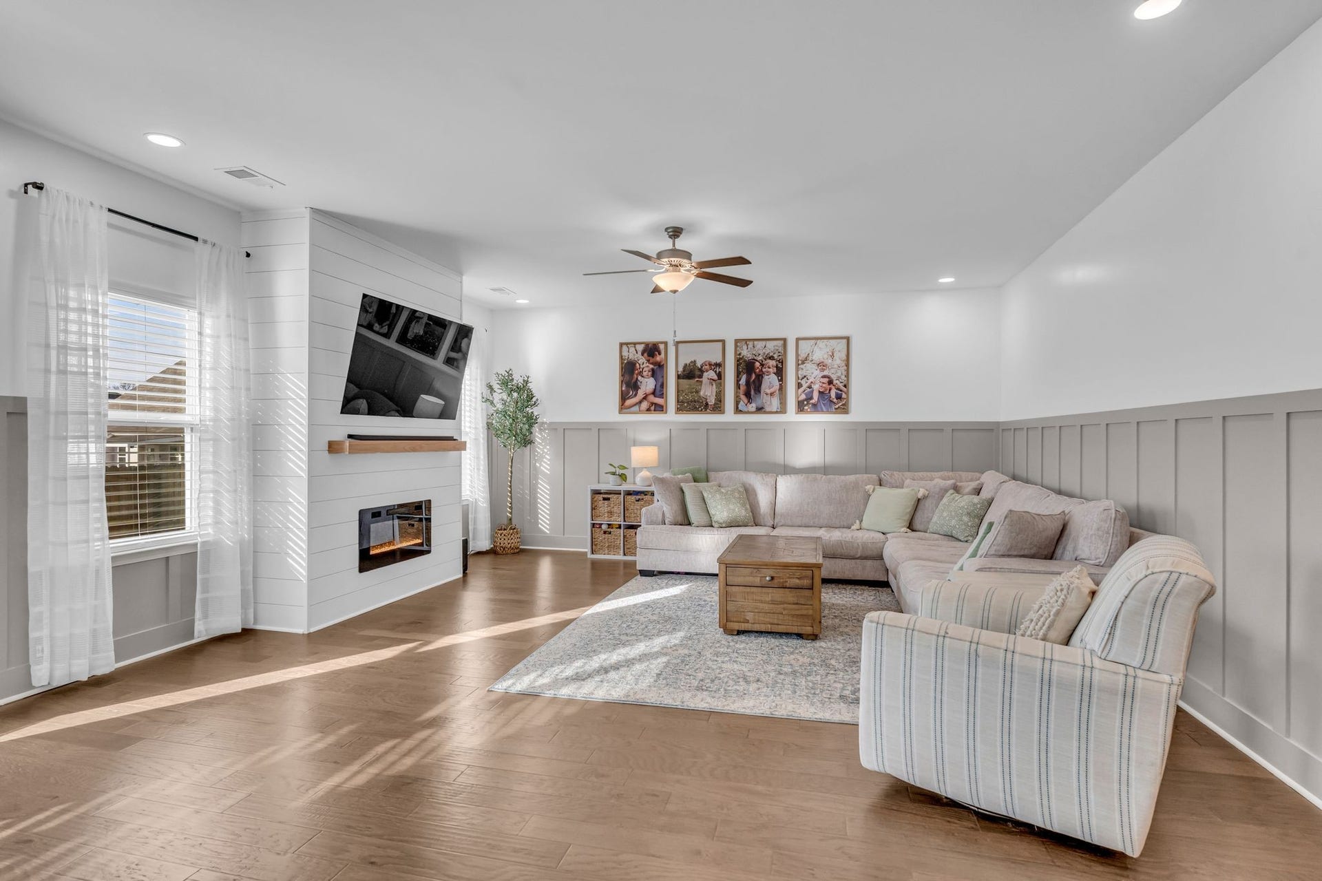 Details like the painted wainscoting and shiplap fireplace surround truly set this home apart.