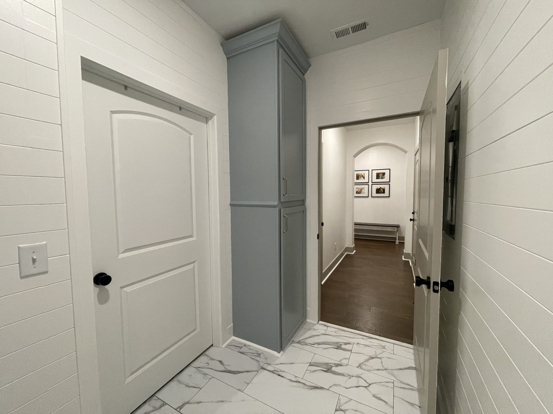 The laundry room was updated with cabinetry, shiplap walls and new flooring.
