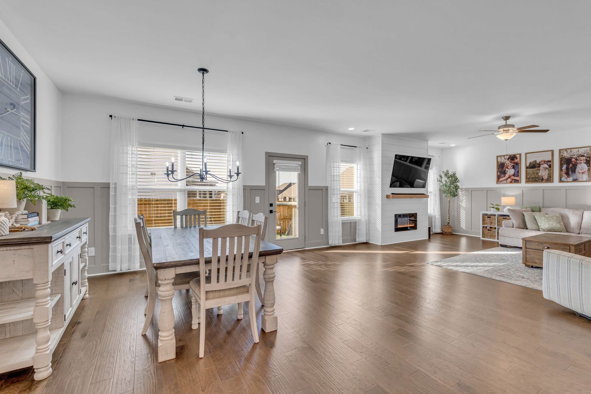 The open layout flows into the living room and the wainscoting surround makes it cohesive and cozy.