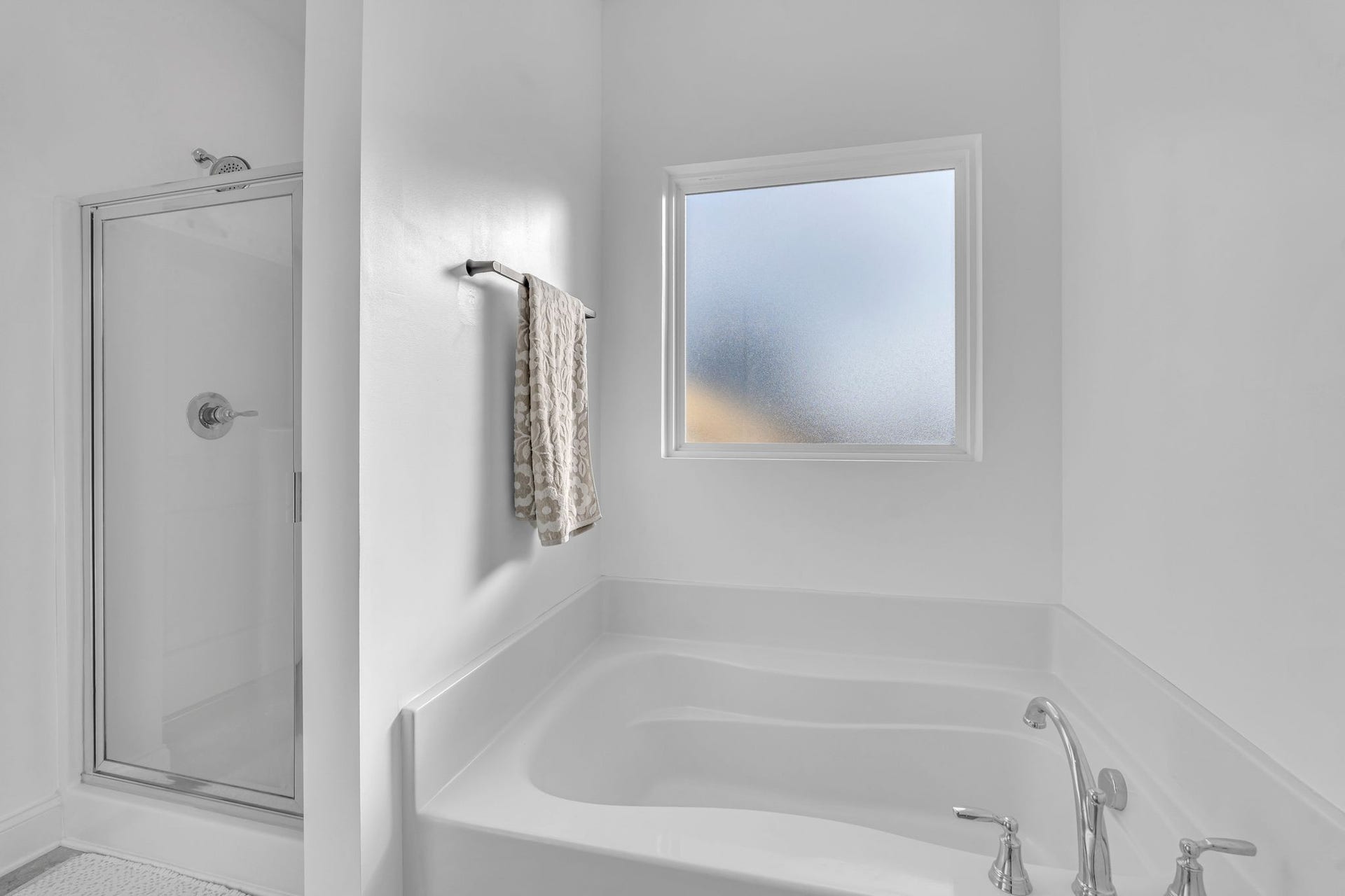 There's a large soaking tub, frosted glass window and separate shower.