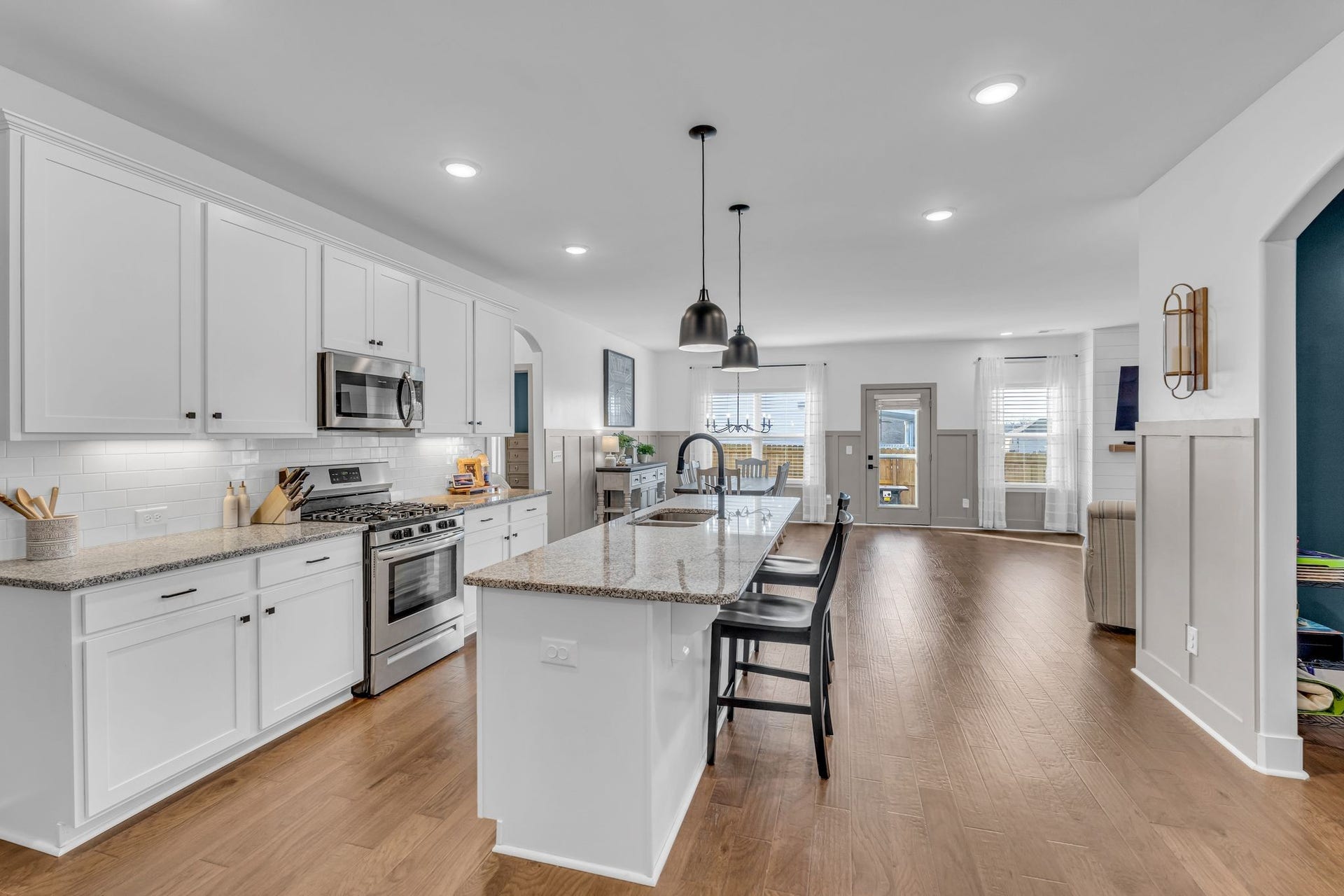 This open layout feels grand with a bright kitchen. (The office on the right now has french doors.)