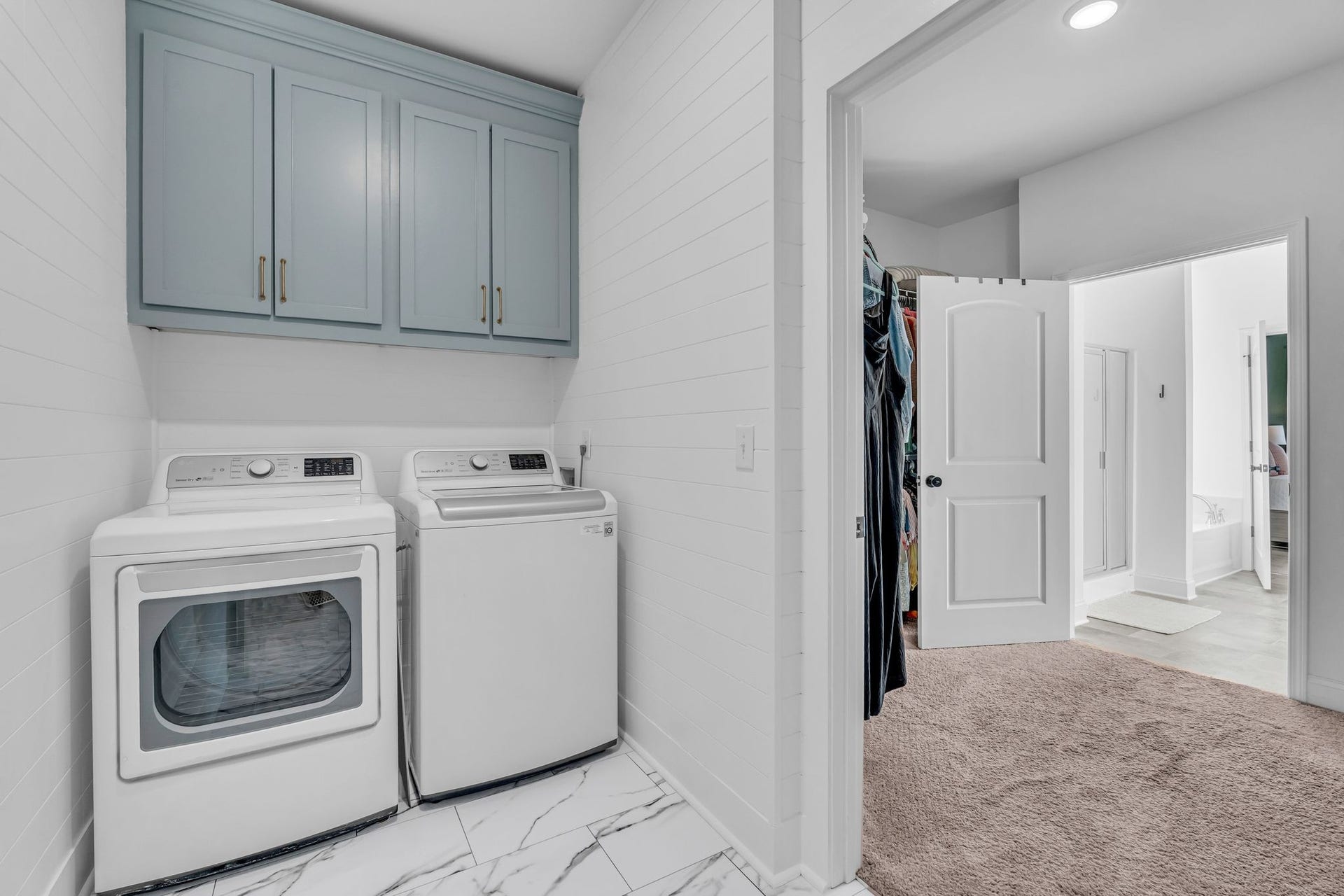 The laundry room was updated with cabinetry, shiplap walls and new flooring.