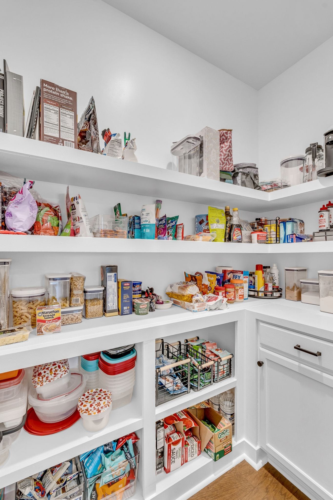 The pantry was customized with wooden shelving and extra cabinet storage.