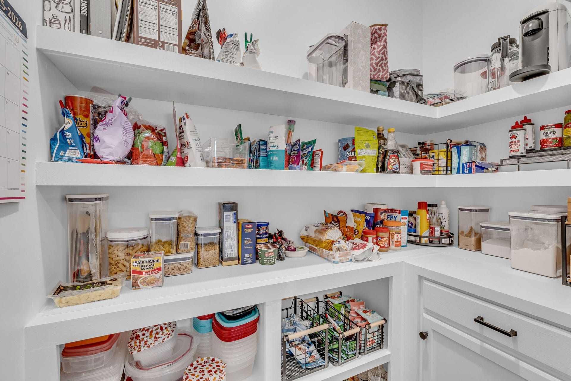 The pantry was customized with wooden shelving and extra cabinet storage.