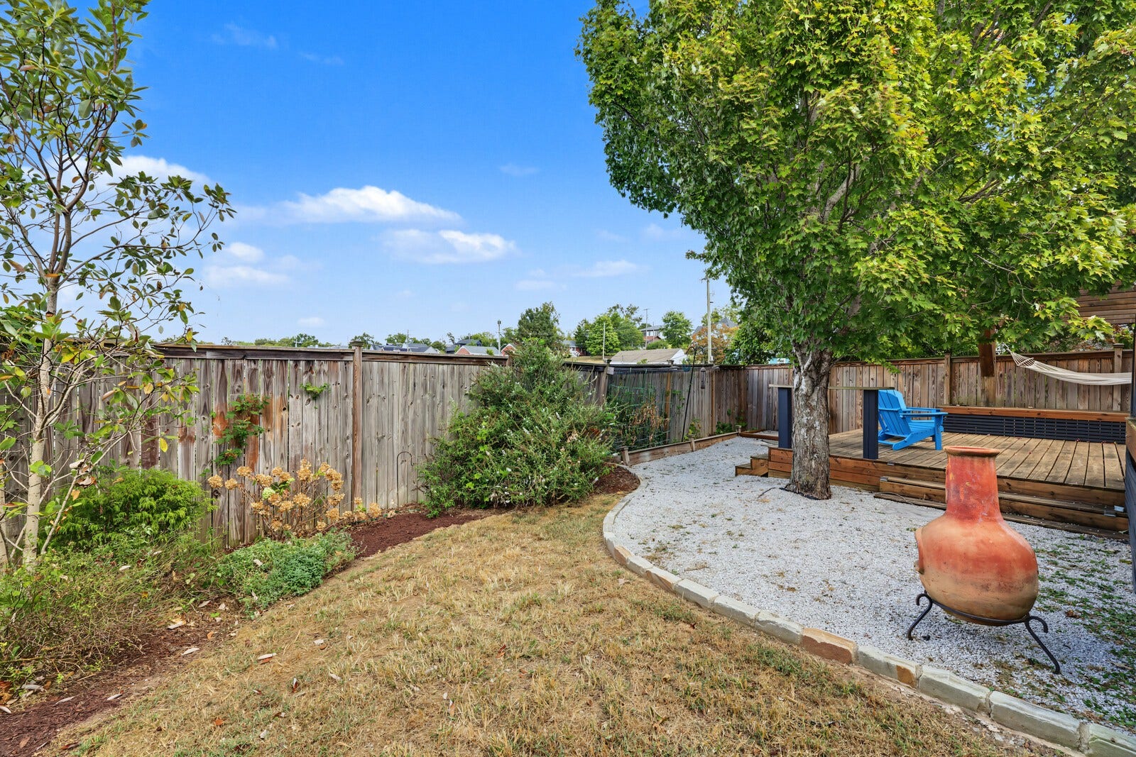 1415 Fatherland St, Nashville, TN 37206 grass, garden beds, sitting areas and a multi-level deck in back