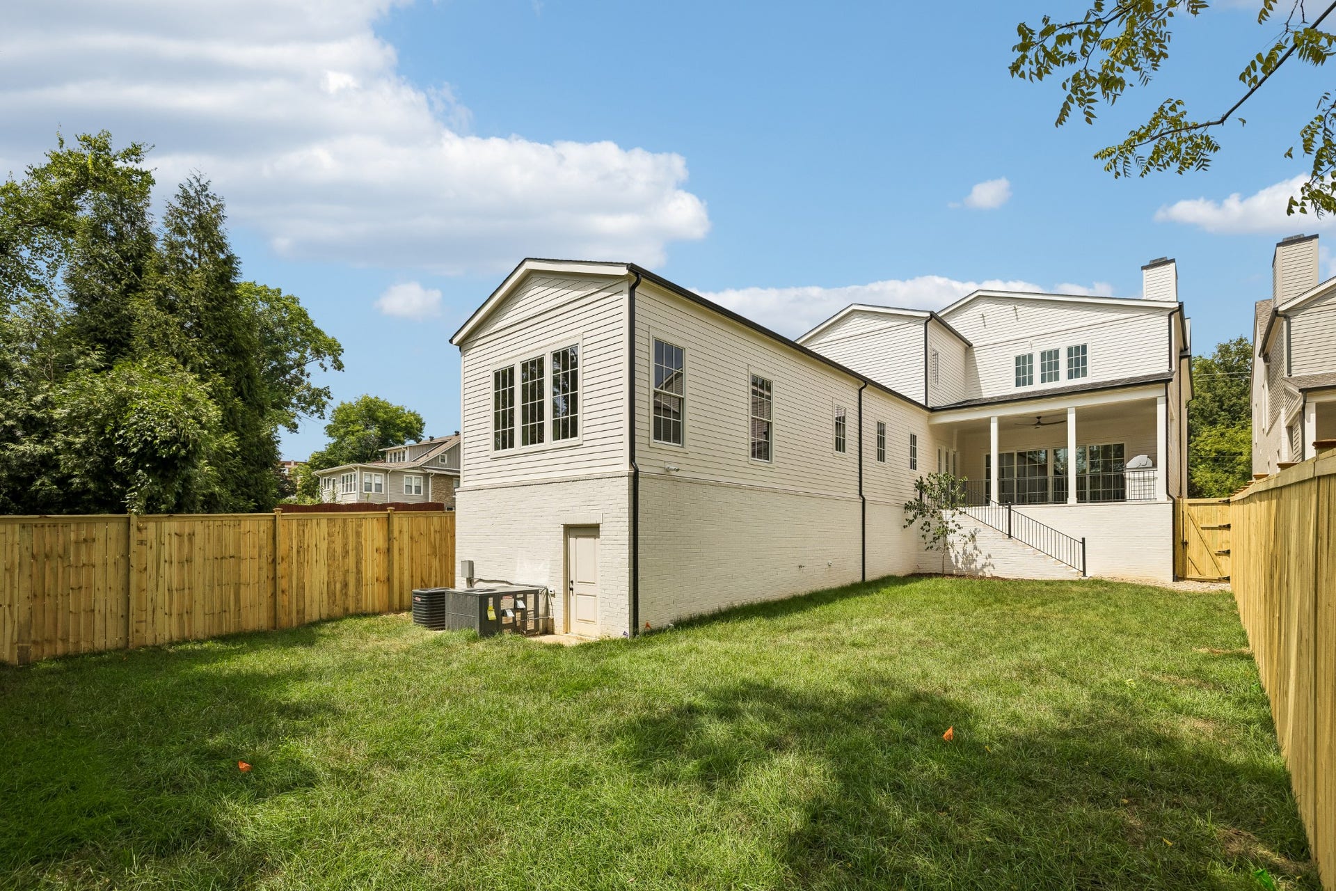 1133 Maplehurst Ln, Nashville, TN 37204 An impressive outdoor package combines a covered porch, outdoor kitchen, ceiling fan, direct access from the main living areas, substantial privacy fencing, large lawn, and convenient walk-in storage below the home.