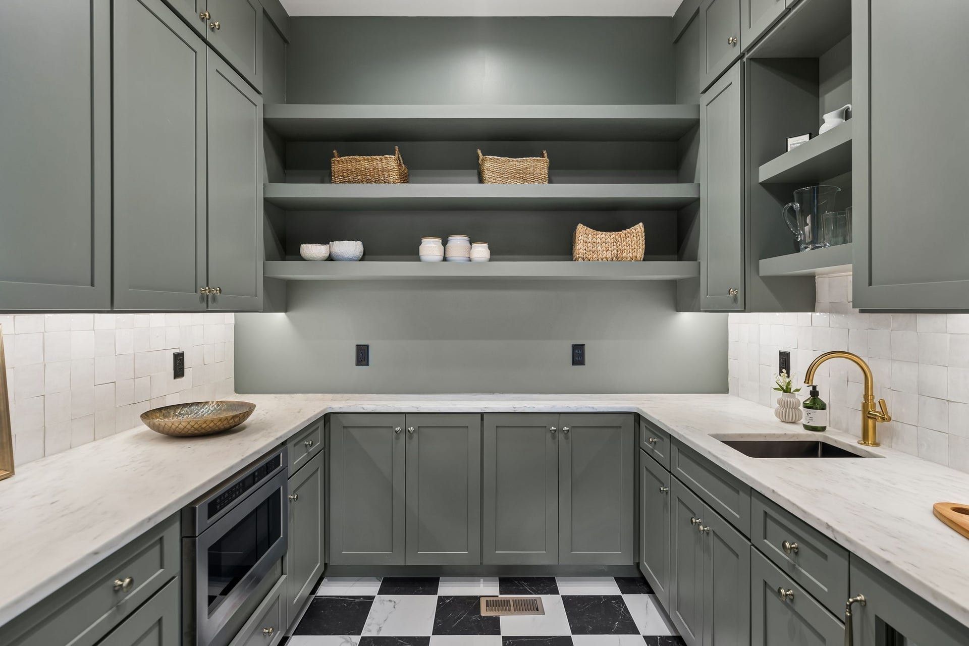 1133 Maplehurst Ln, Nashville, TN 37204 Exceptional prep kitchen offers extensive cabinetry, open shelving, stone countertops, sink, and additional appliancesperfect for entertaining, meal prep, and keeping the main kitchen clutter-free.